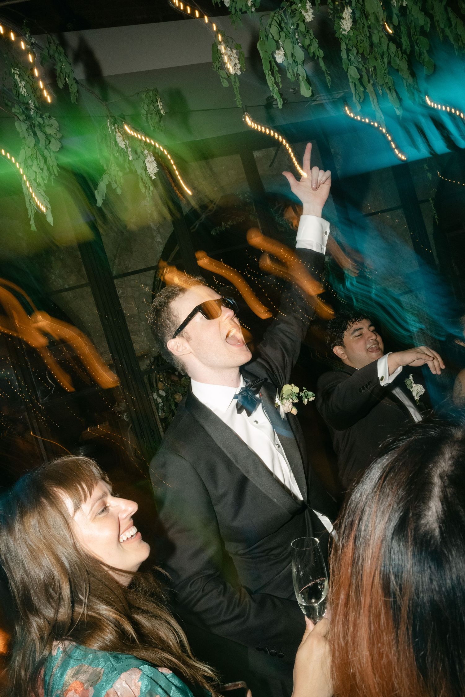 Party scene with colorful lighting and dancing silhouettes creating energetic nightlife atmosphere.