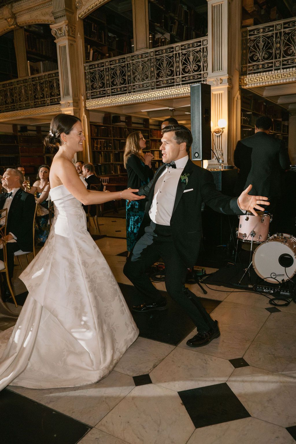 Wedding couple performing a dance move on the reception floor.