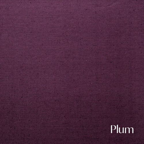 A solid plum purple colored textile background with a subtle woven texture and rich deep hue.