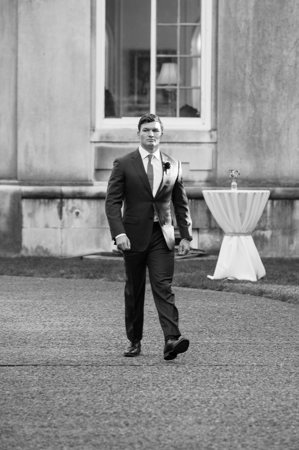 Black and white image of formal attire on a gravel courtyard outside a stately building at Strong Mansion on Sugarloaf Mountain