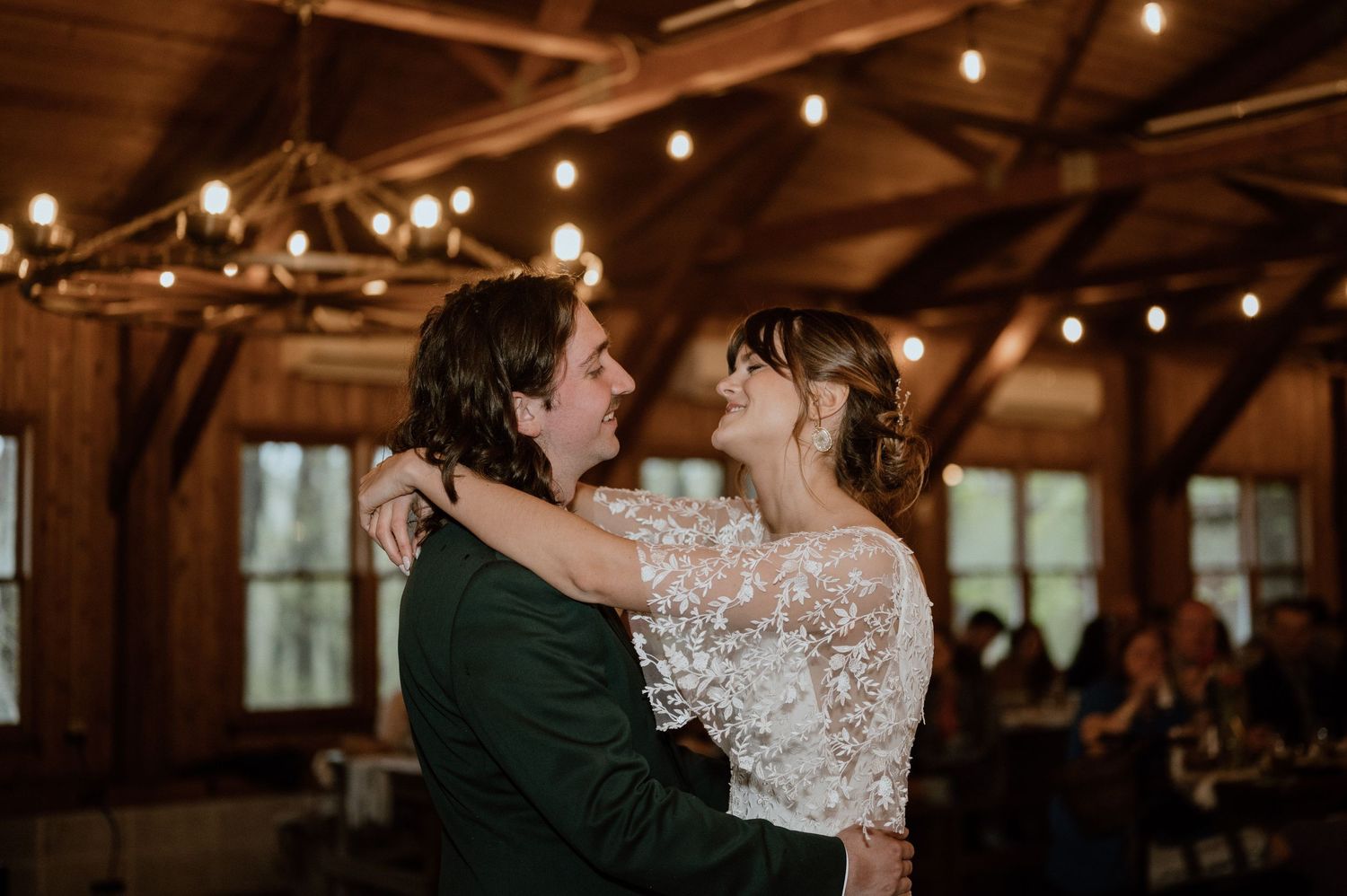 Couple embracing during an intimate moment on their wedding day in a wooden barn venue.