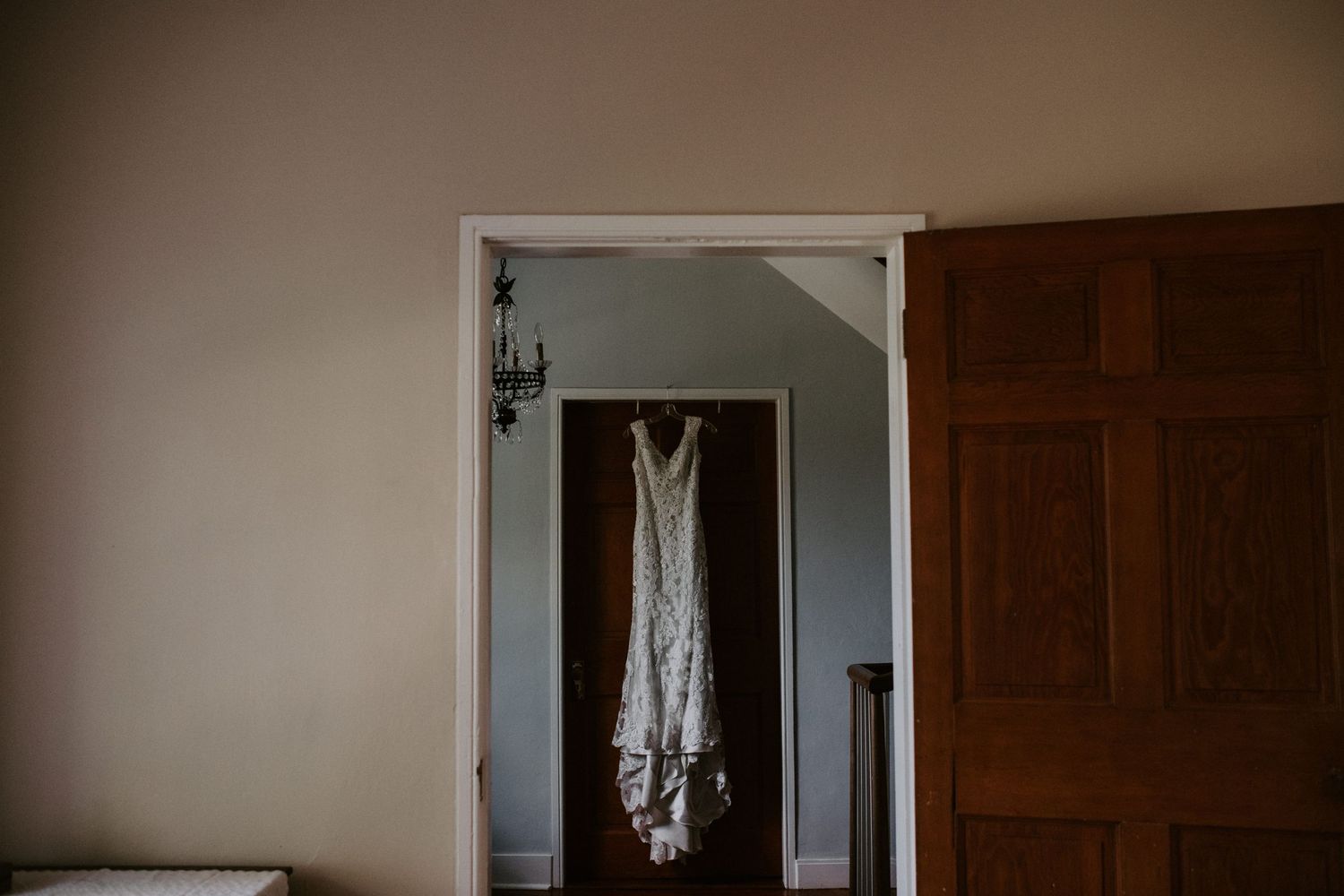 Wedding dress hanging in a doorframe before the ceremony.