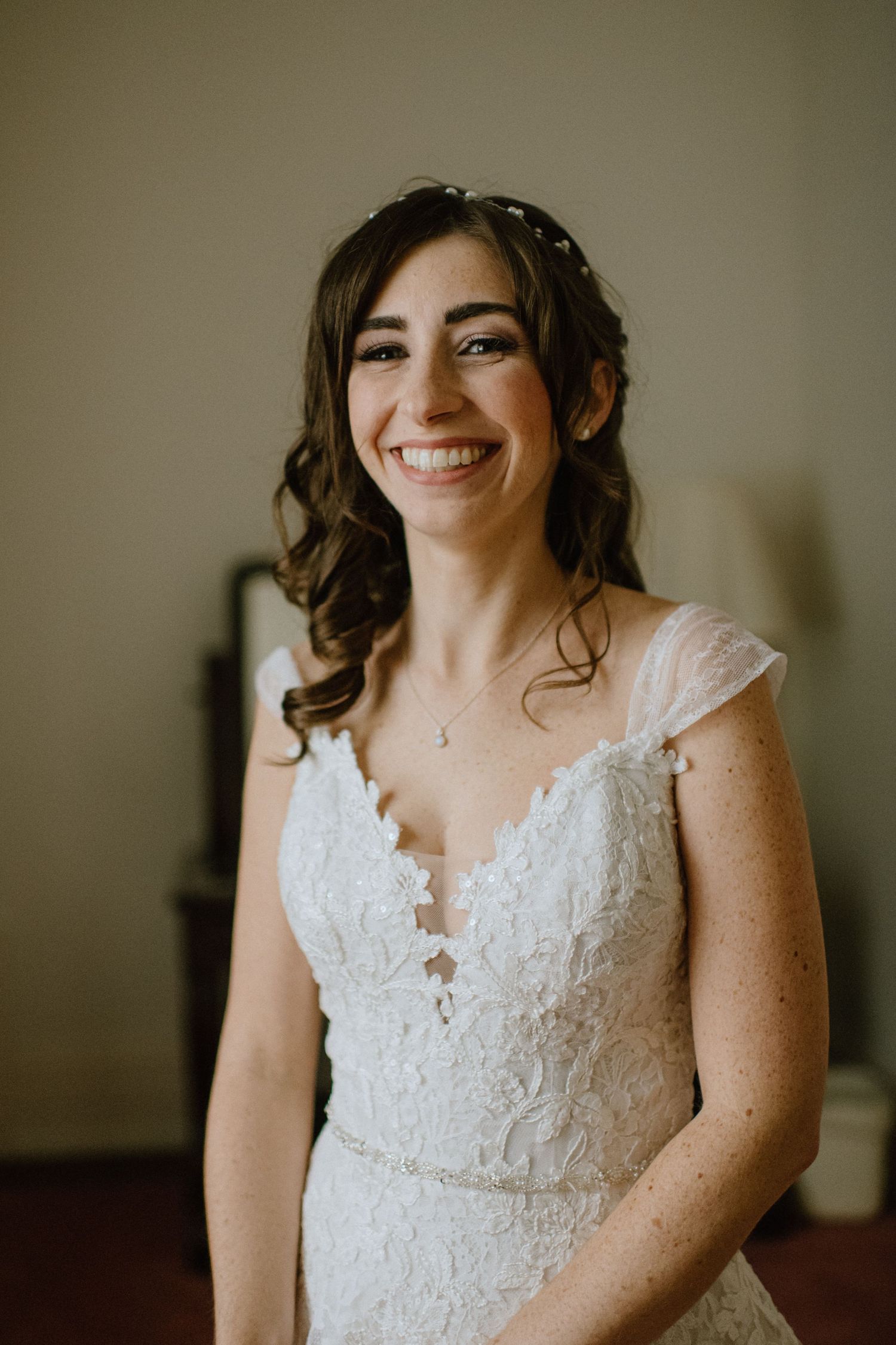 bride in lace wedding dress smiling