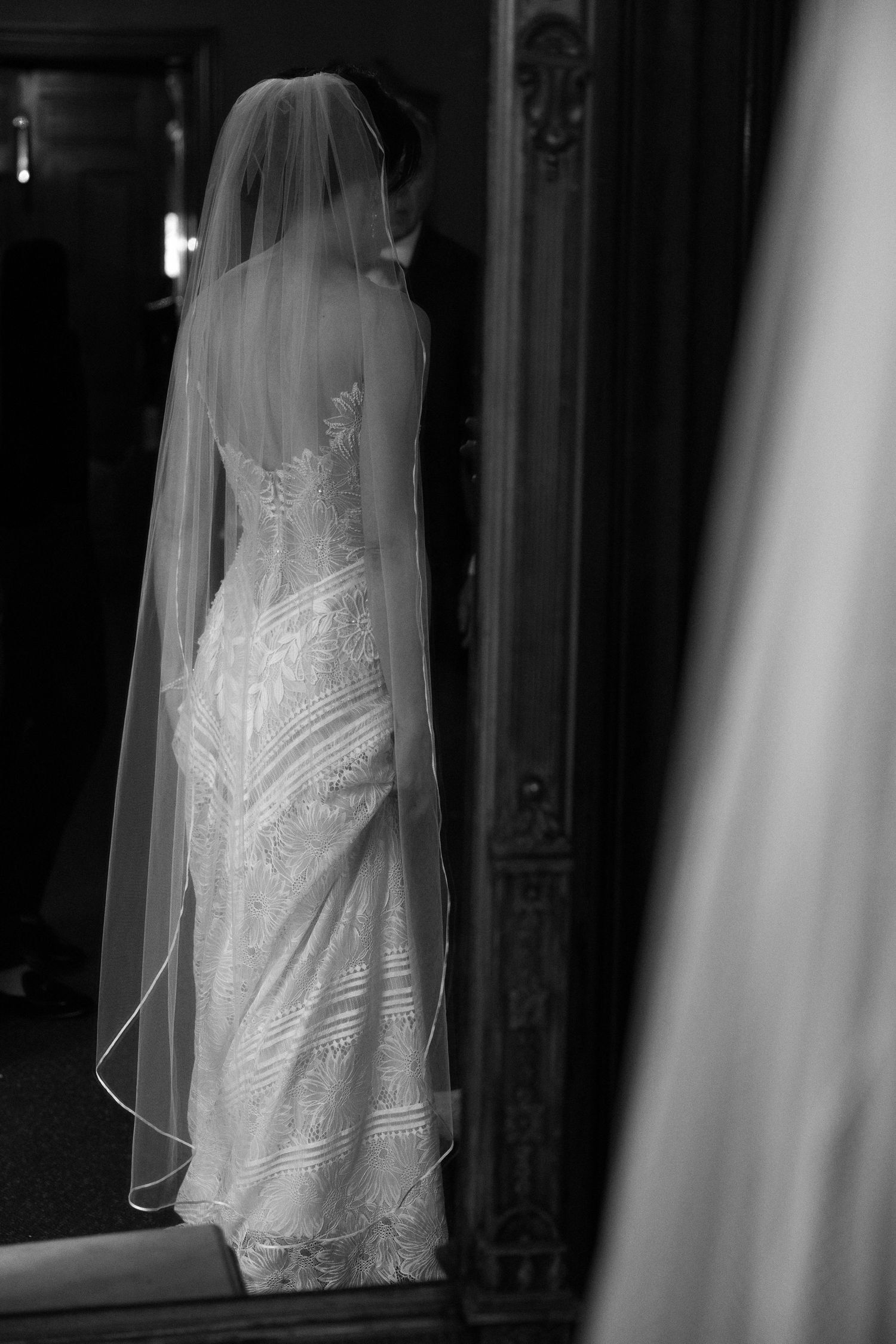 Artistic black and white shots of a bridal gown with delicate veil and lace details.