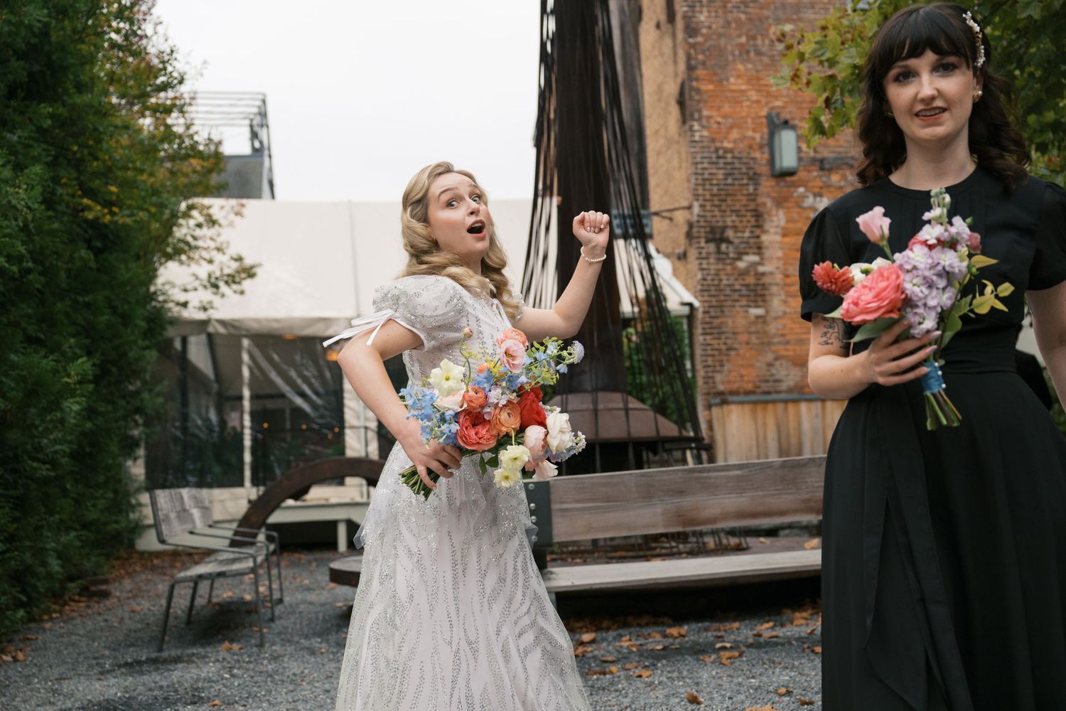 Wedding celebration outside a brick building with joyful moments and floral bouquets.