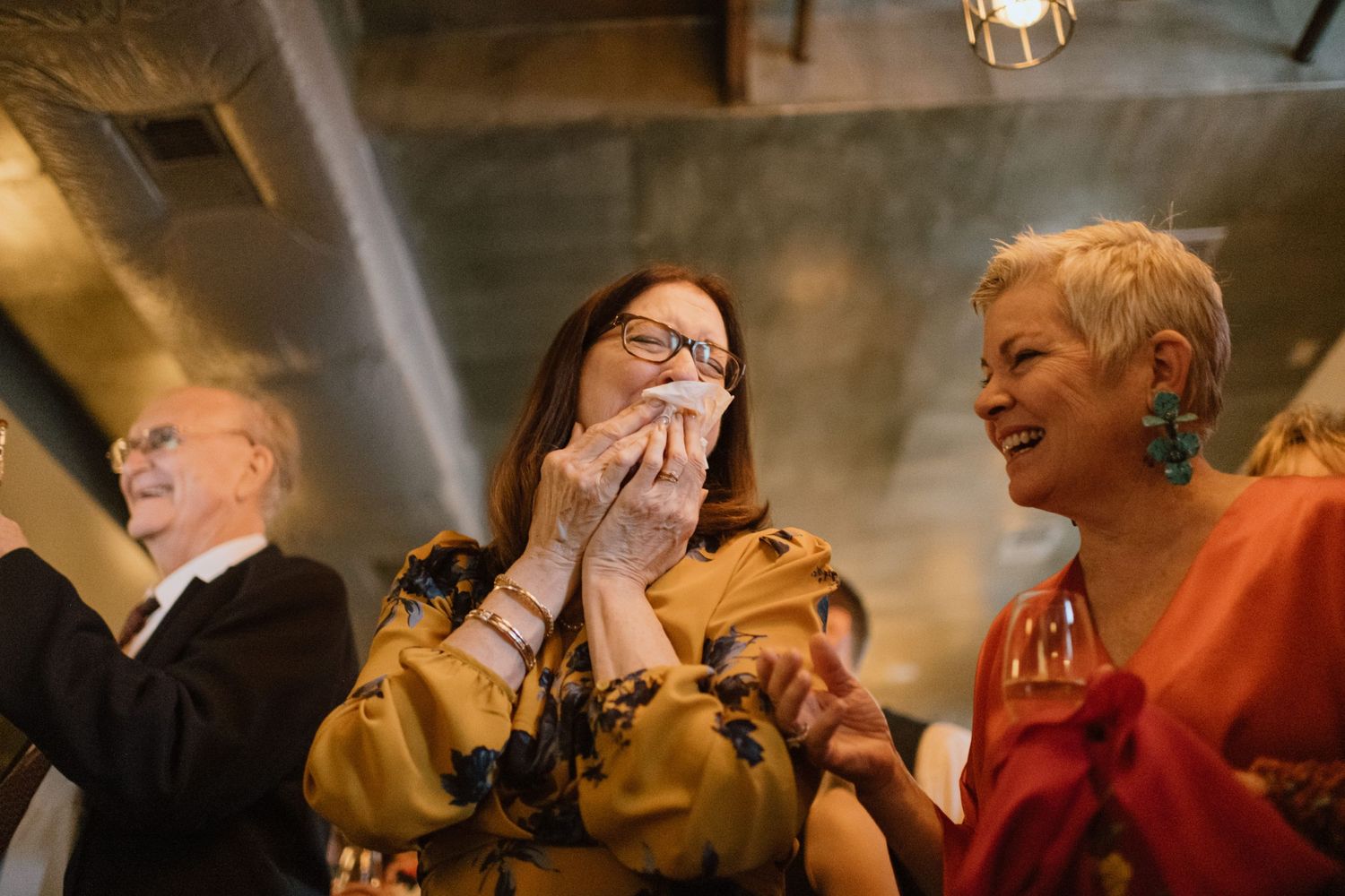 Wedding guests express joy and emotion during the ceremony celebrations.