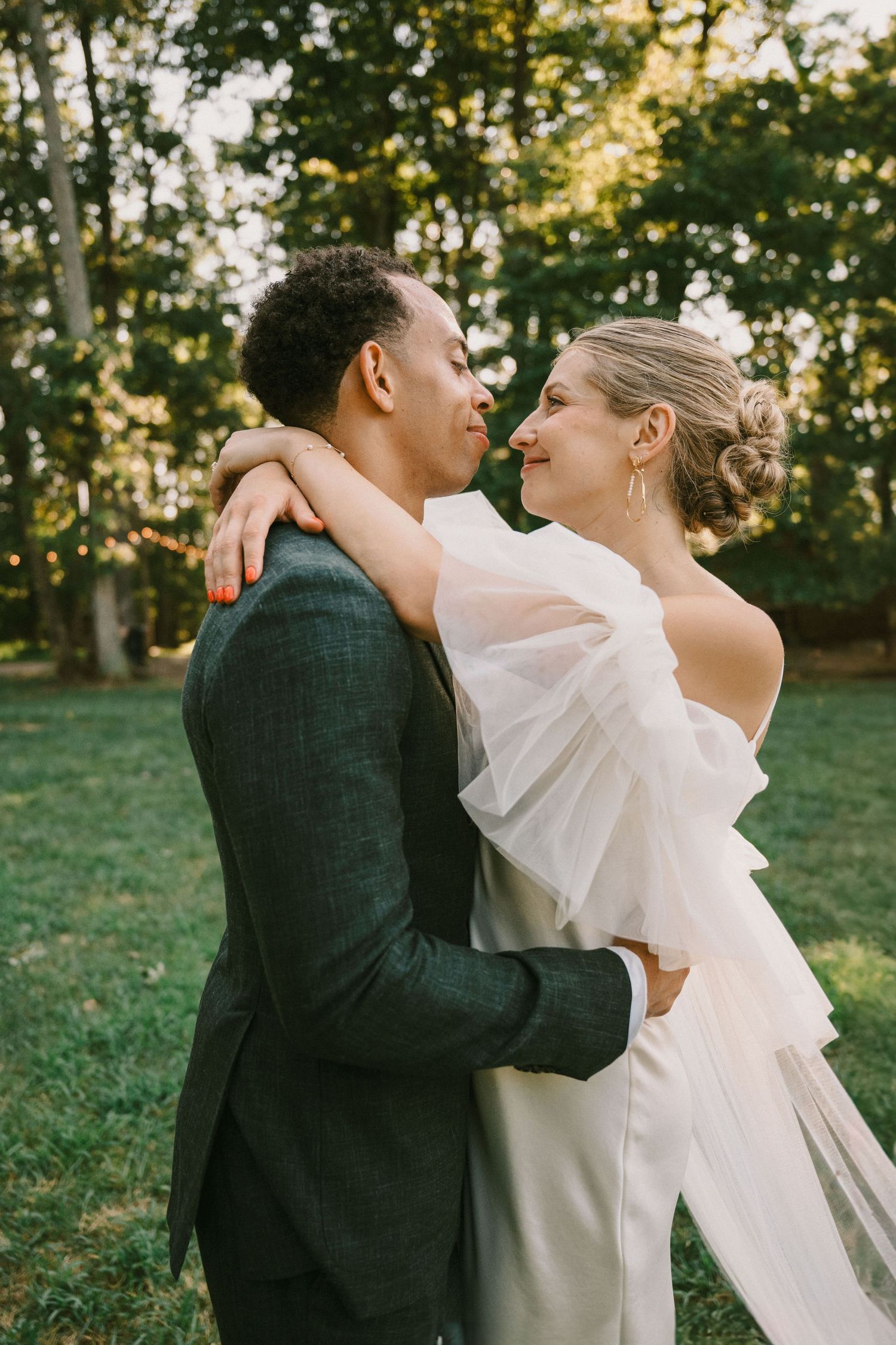 A candid moment between newlyweds laughing together during their outdoor wedding photoshoot.