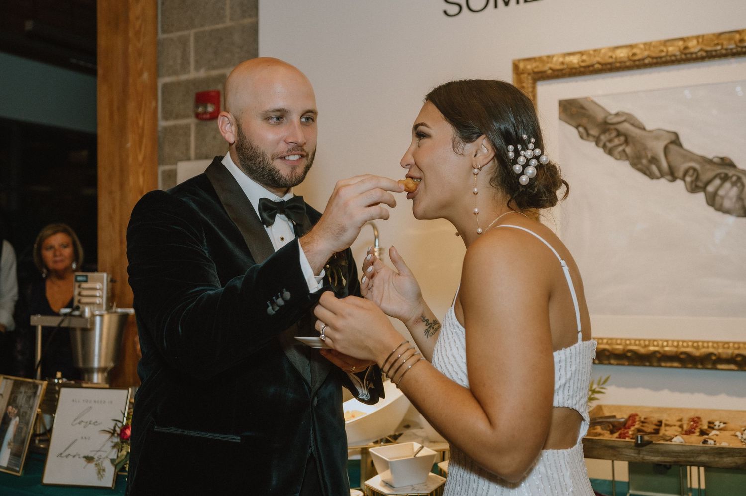 A playful moment between newlyweds during their wedding reception celebration.