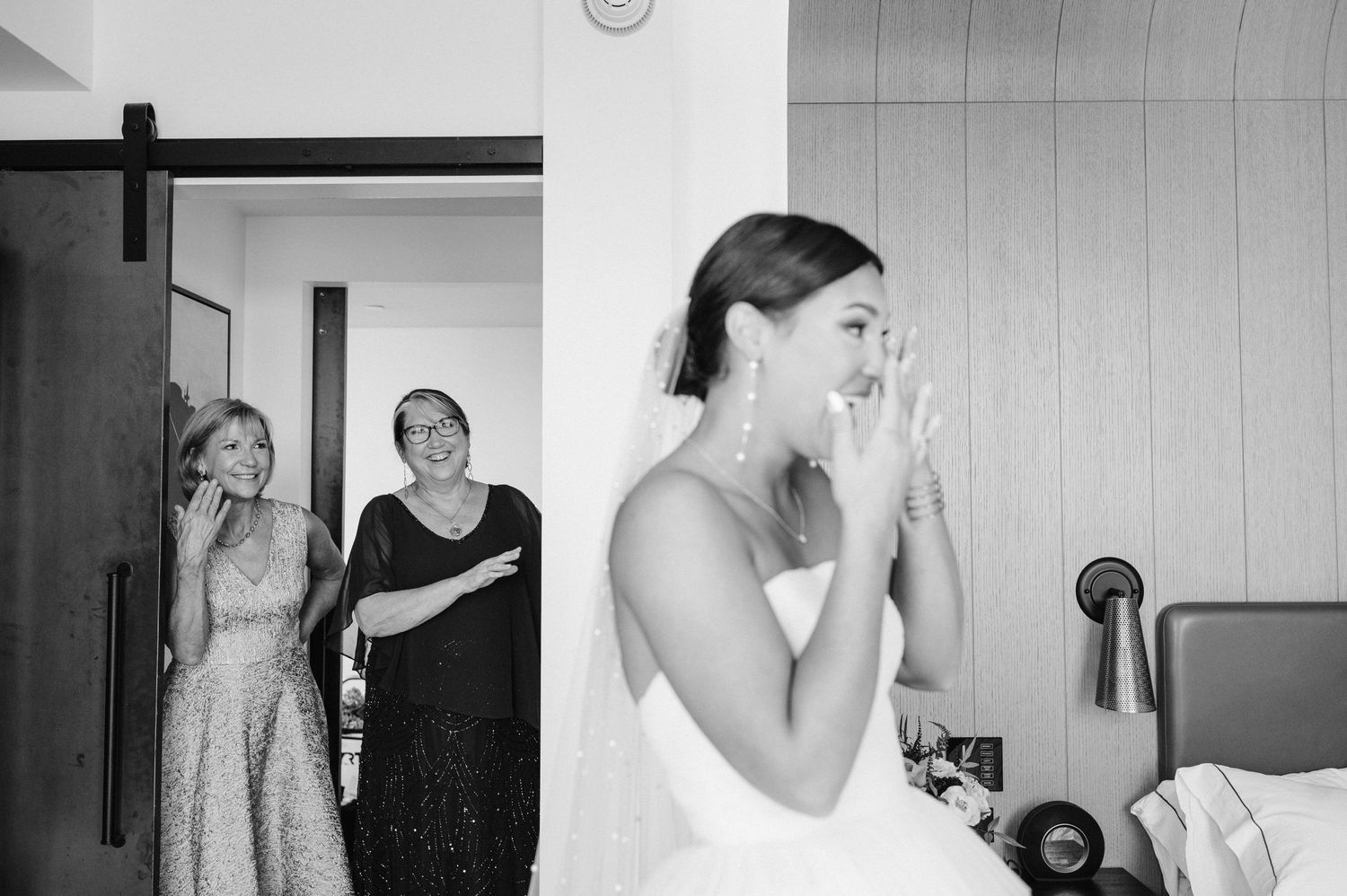Emotional black and white moment during bridal preparation.