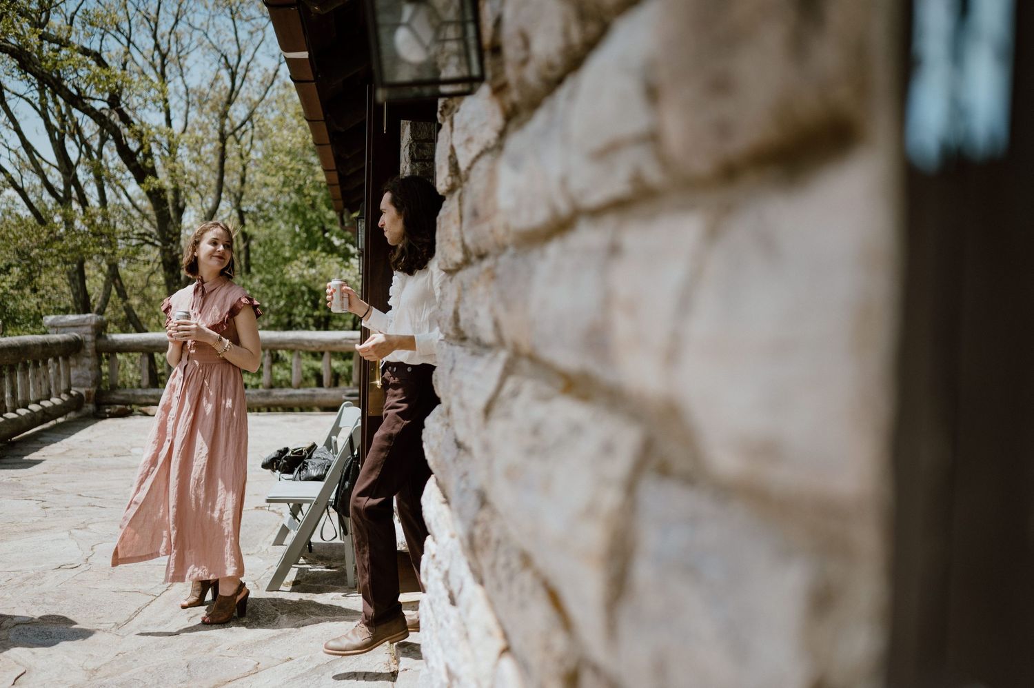 Stone wall creates dramatic backdrop for outdoor mountain lodge setting.