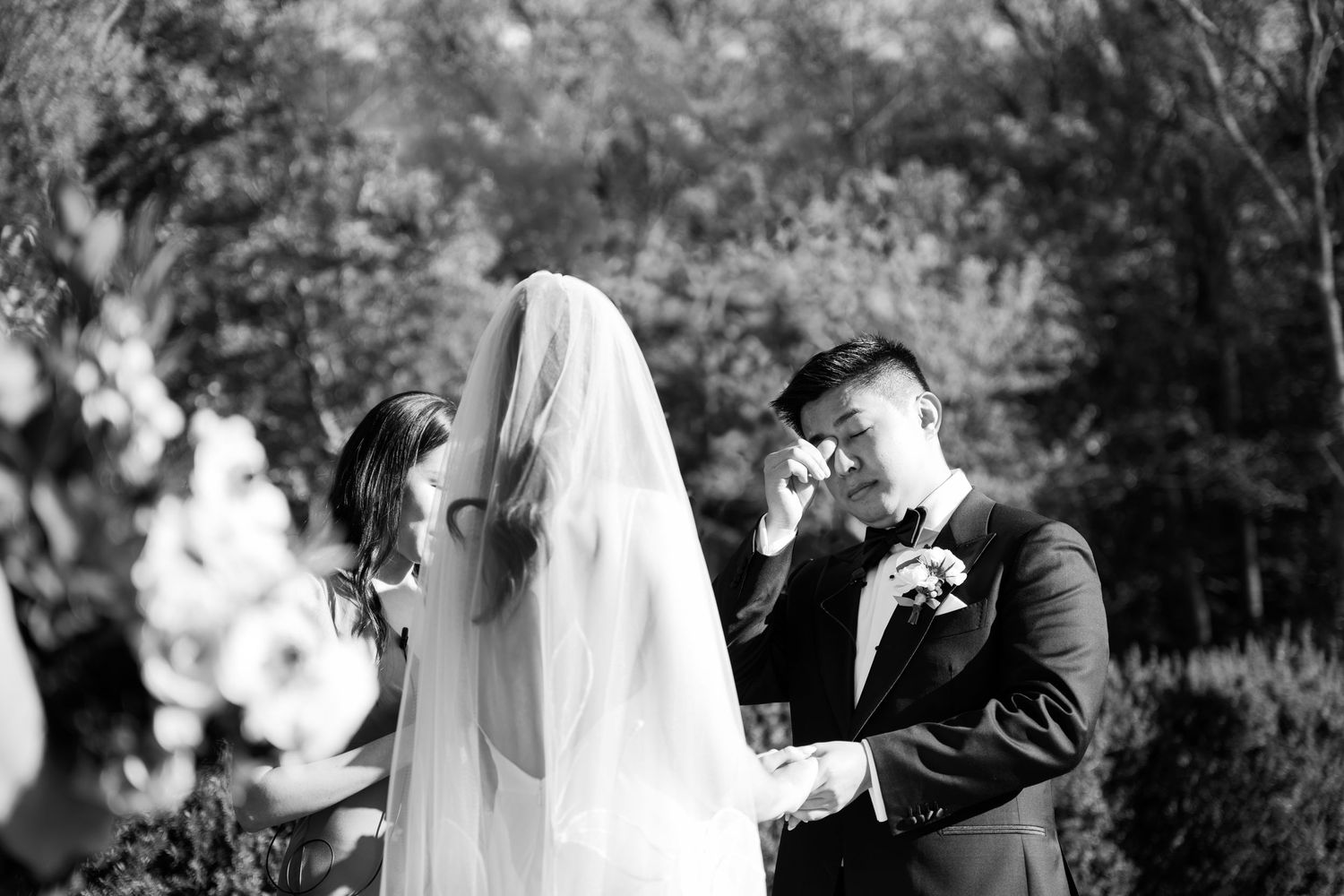 Black and white outdoor wedding portraits showing intimate moments between the couple.