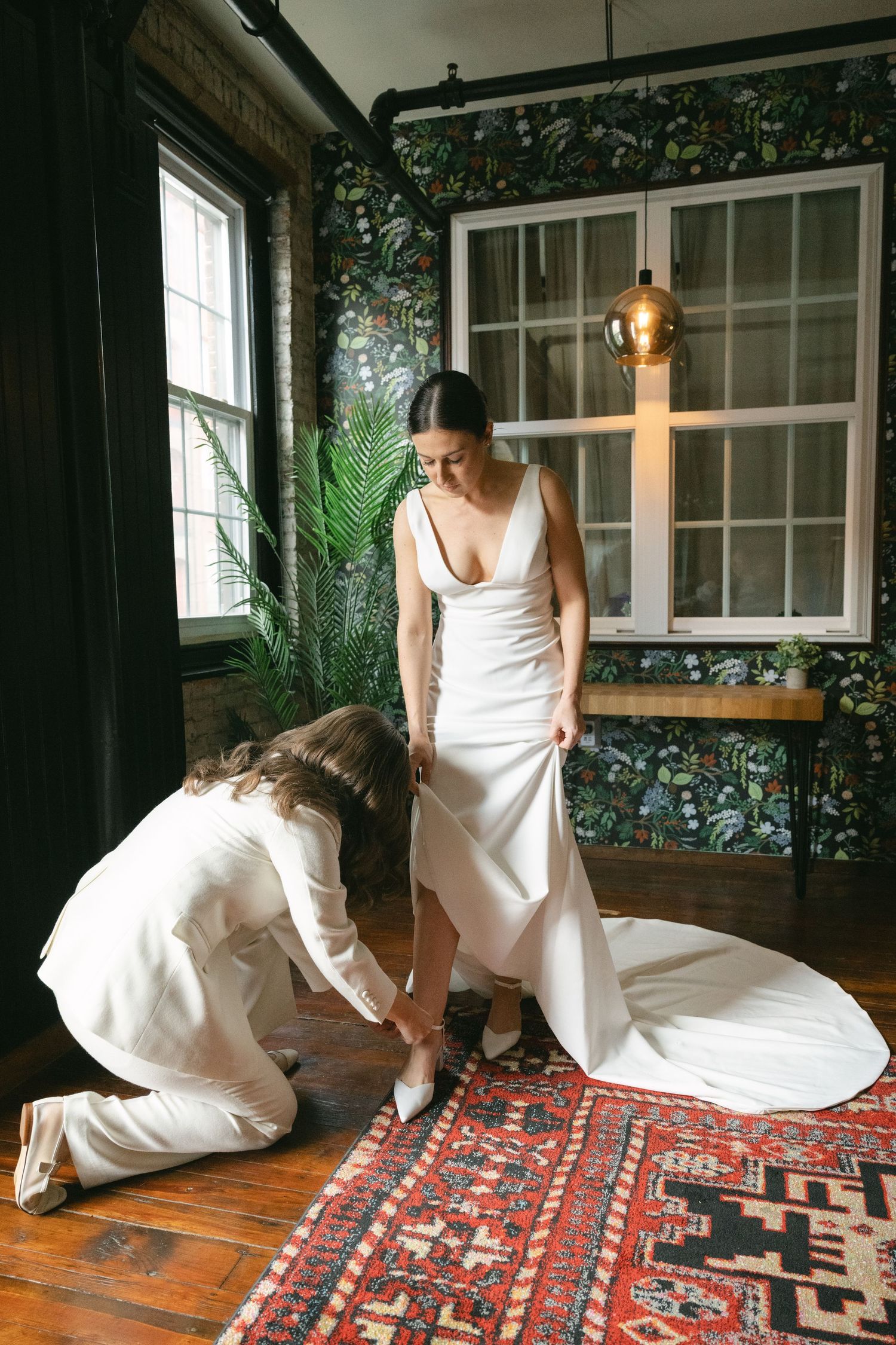 Sequential photos of someone adjusting a white dress while sitting on a colorful patterned rug.