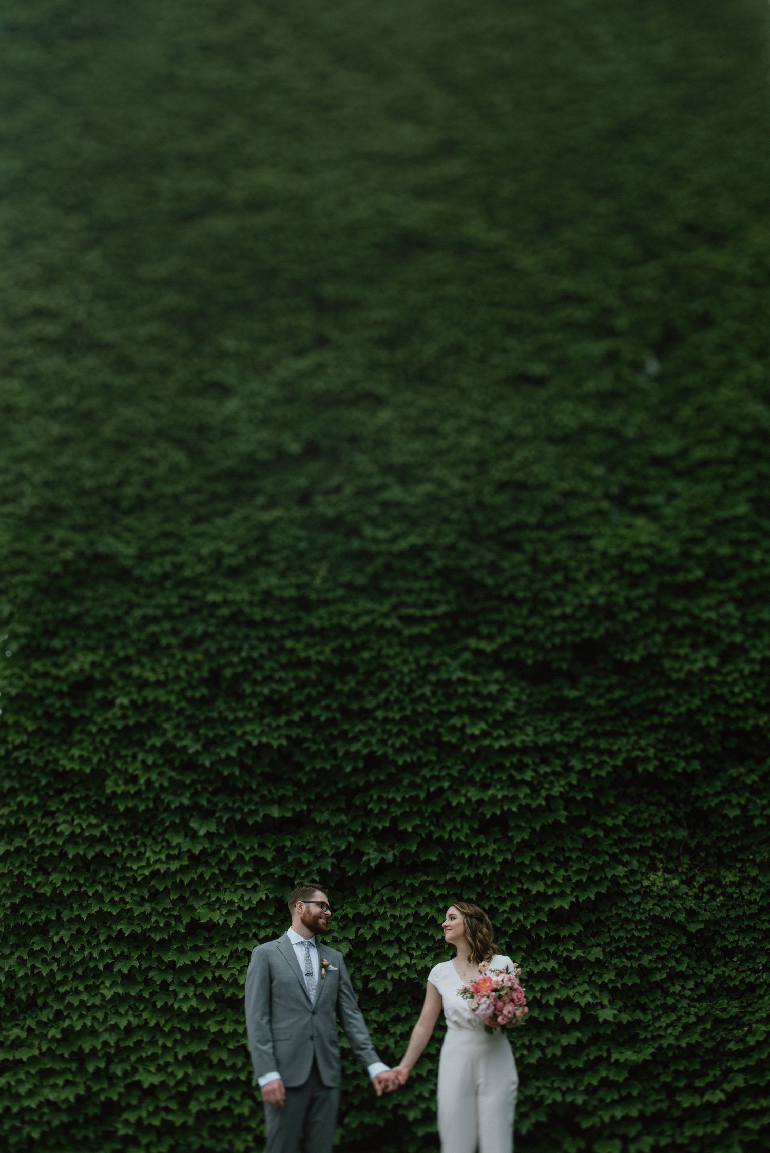 Black and white street scene with a wedding couple walking past Eddie's storefront.