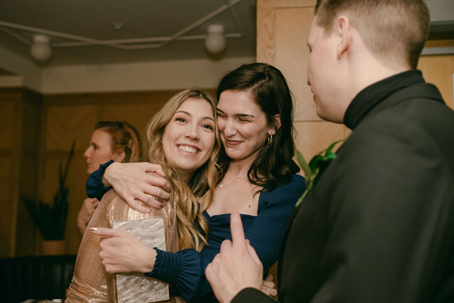 Wedding guests sharing joyful moments during evening reception.