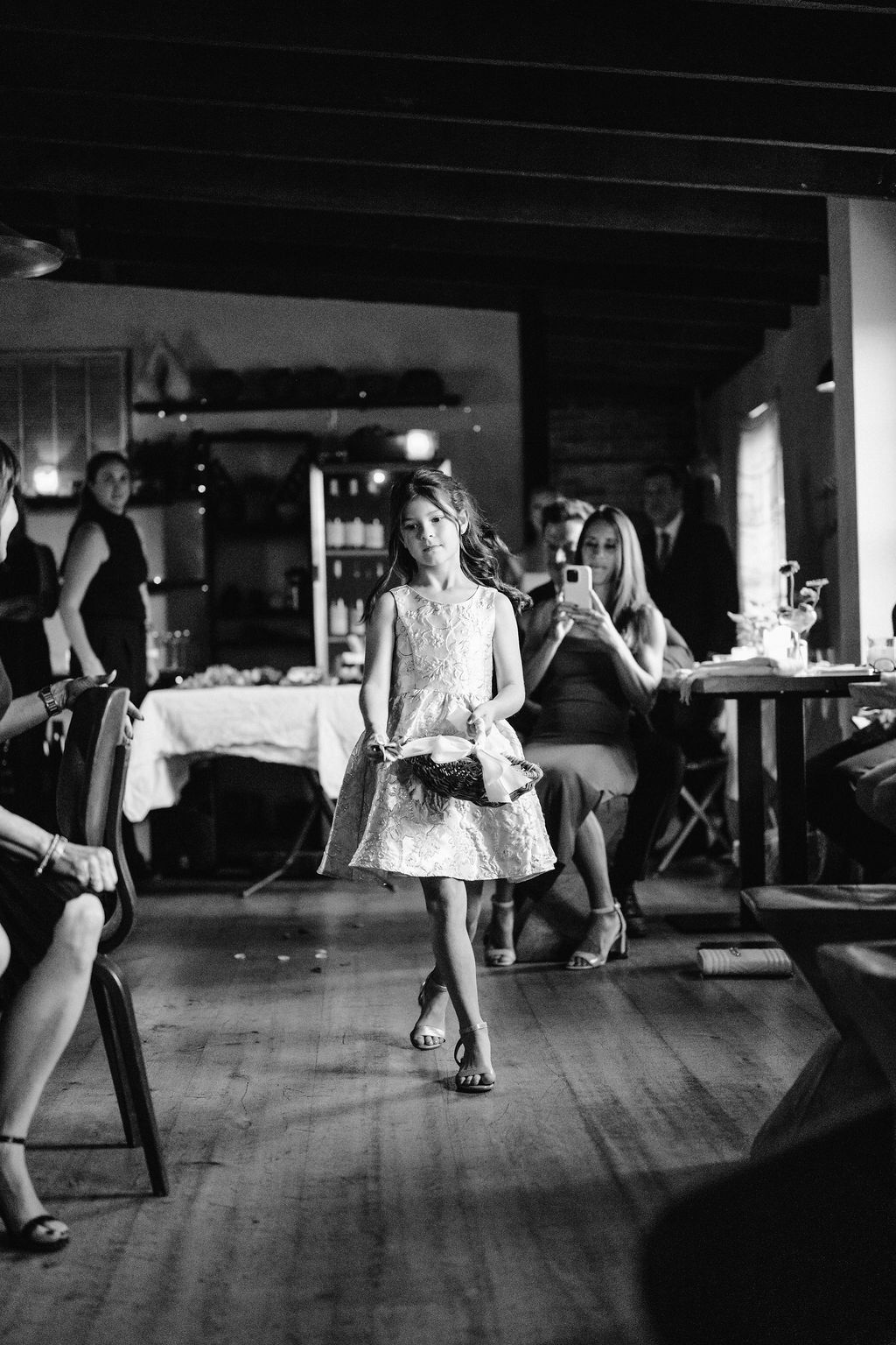 Black and white photo of wedding guests dancing energetically on a wooden dance floor Fadensonnon in Baltimore