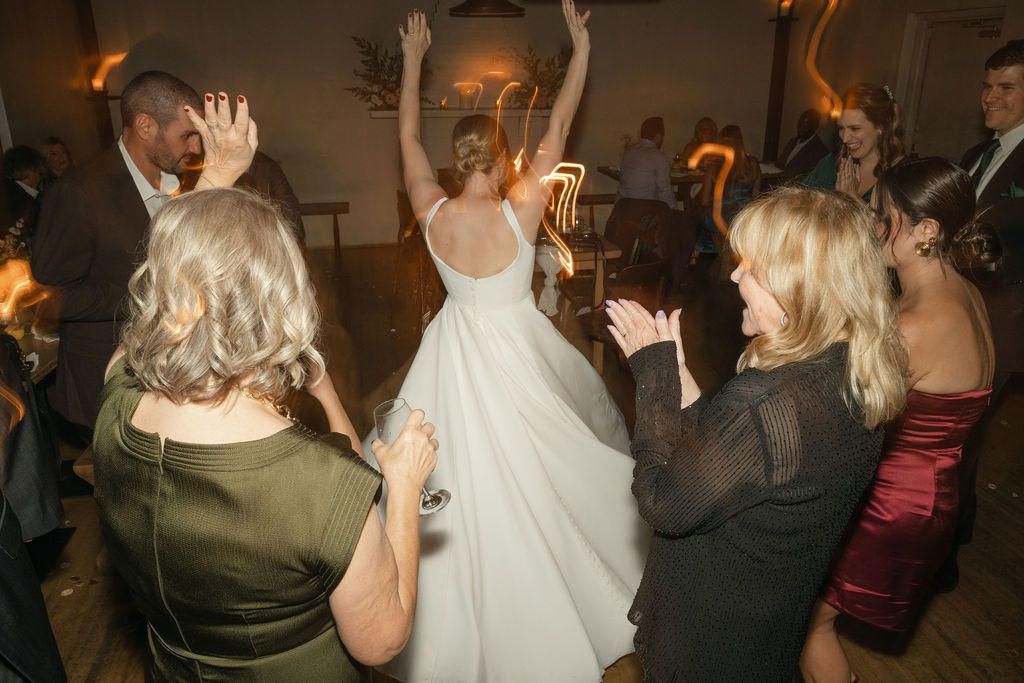 Wedding reception dance party with guests celebrating on the dance floor Fadensonnon in Baltimore