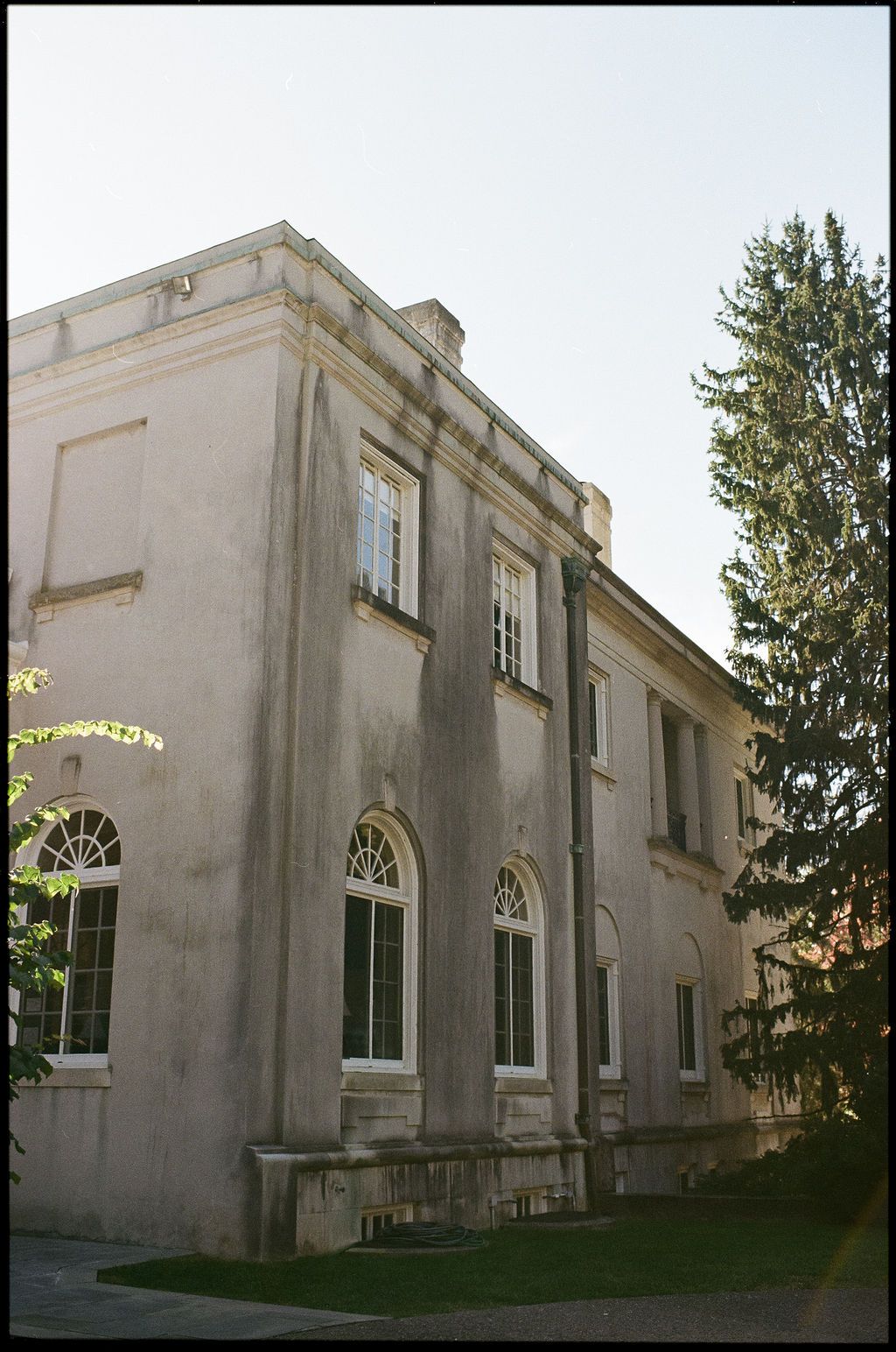 Exterior view of a historic white stone building with arched windows and classical architecture at Strong Mansion on Sugarloaf Mountain