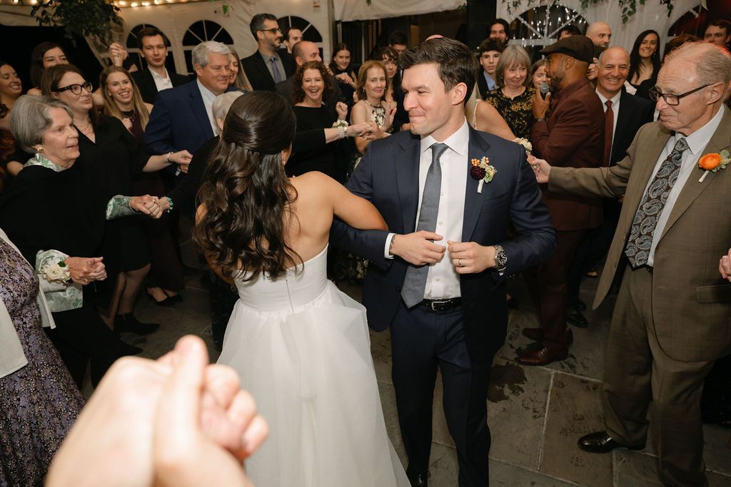A joyous celebration on a crowded dance floor at an indoor reception at Strong Mansion on Sugarloaf Mountain