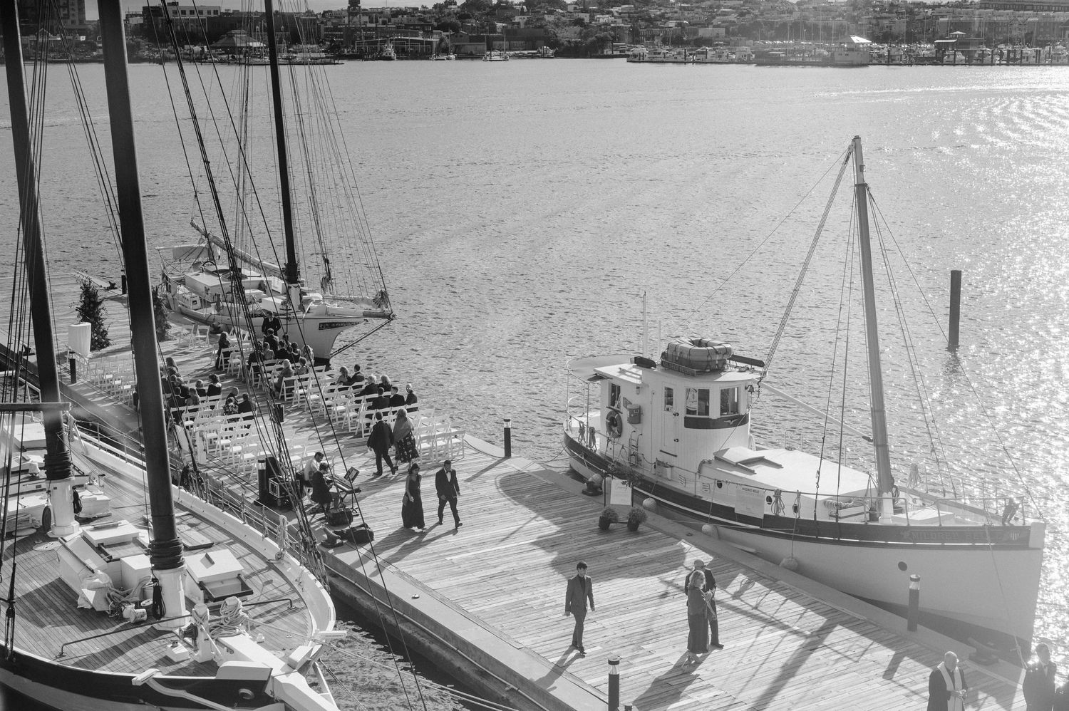 Vintage black and white photo of boats docked at maritime harbor.