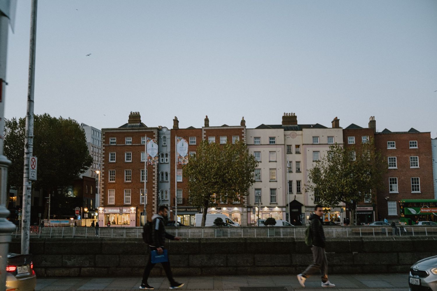 Row of classic Georgian style buildings along a street in Dublin at sunset.