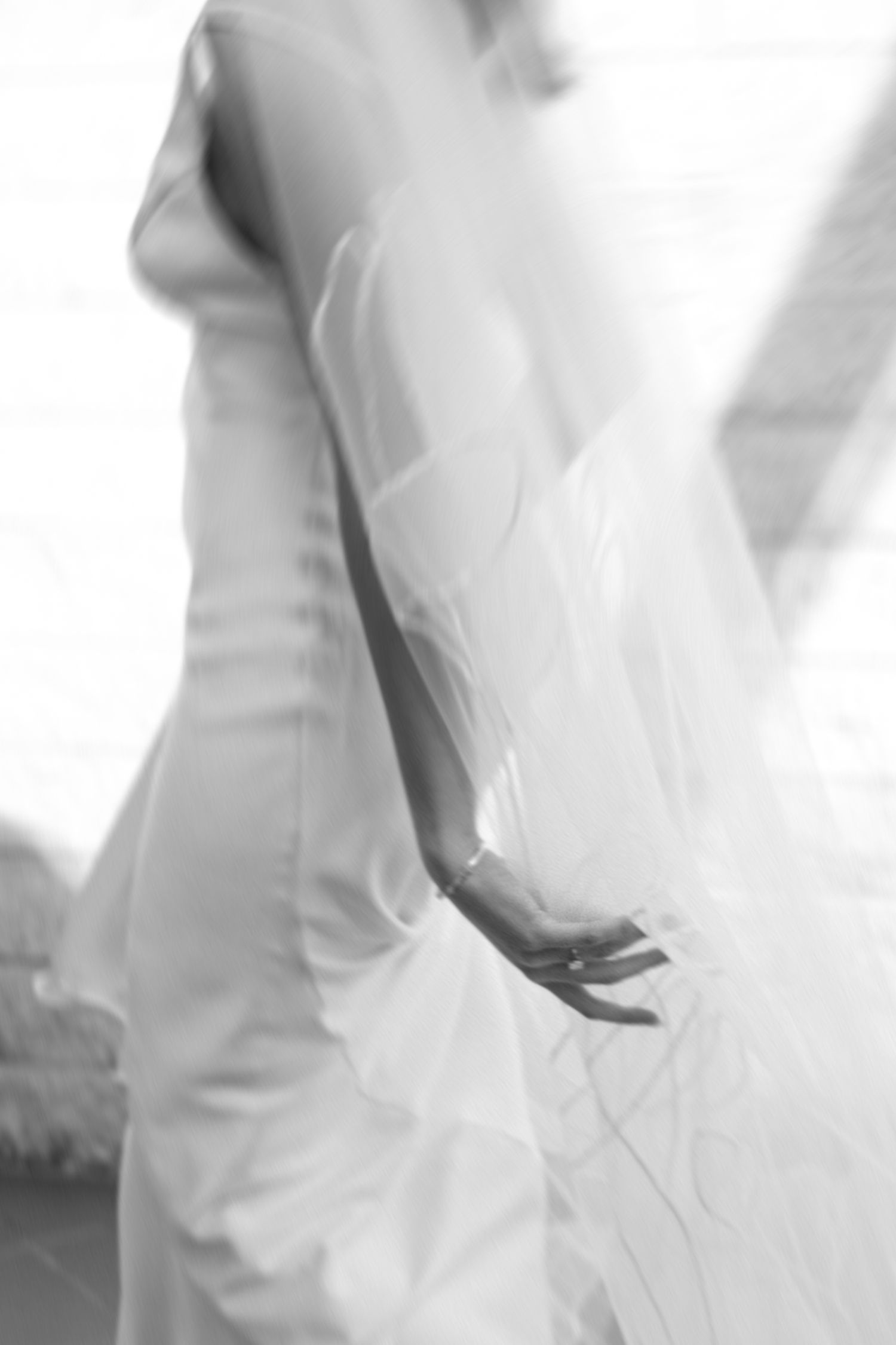 Abstract close-up shots of flowing white wedding dress fabric in soft lighting.