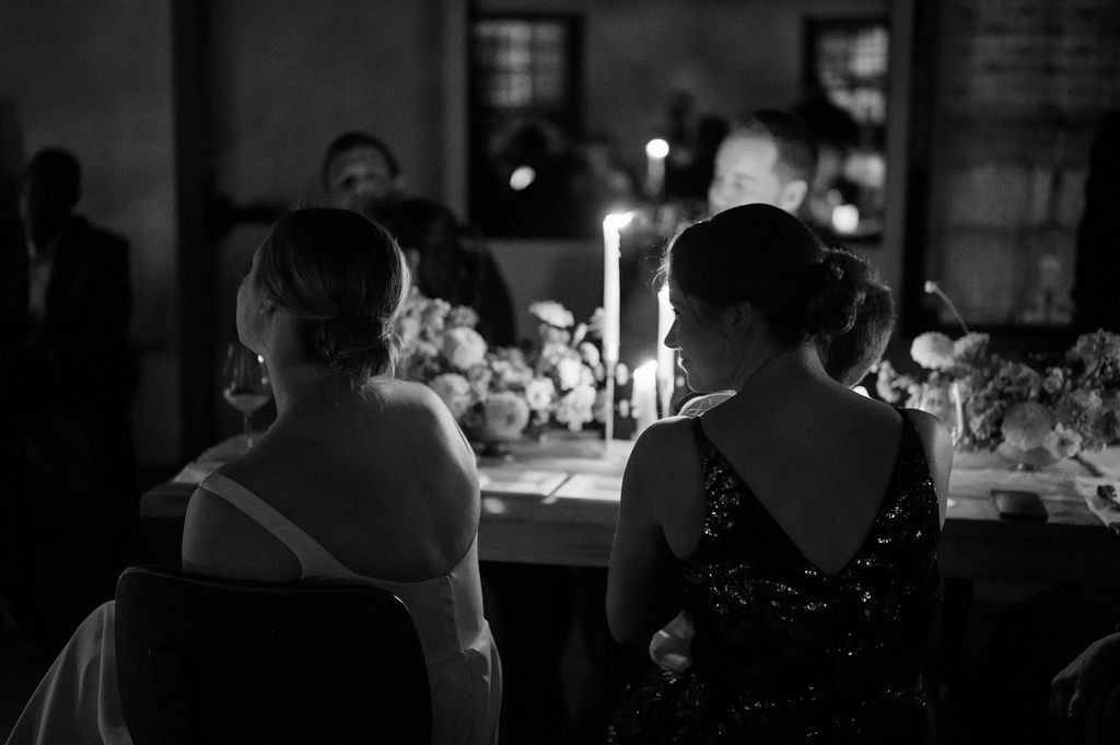Candlelit gathering captured in dramatic black and white photography Fadensonnon in Baltimore
