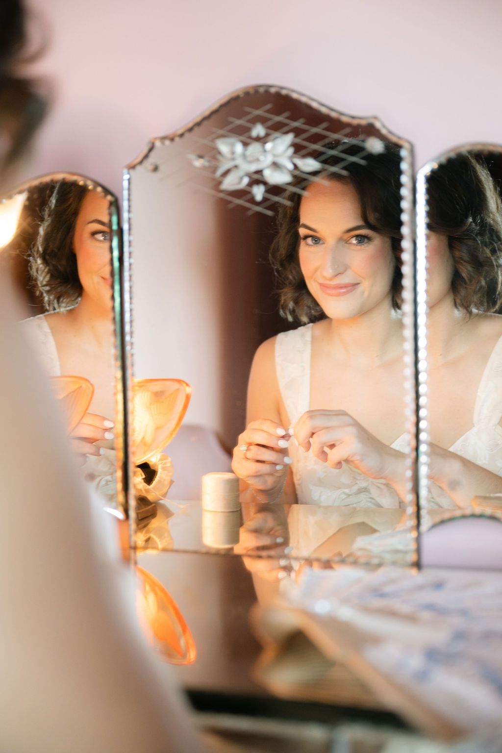 A series of reflective mirror images showing someone with dark hair in a warm, intimate lighting setting.