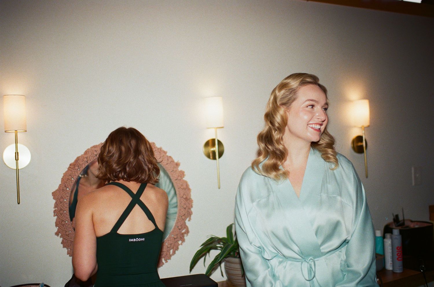 Two people share a laughter-filled moment while preparing for a special event.