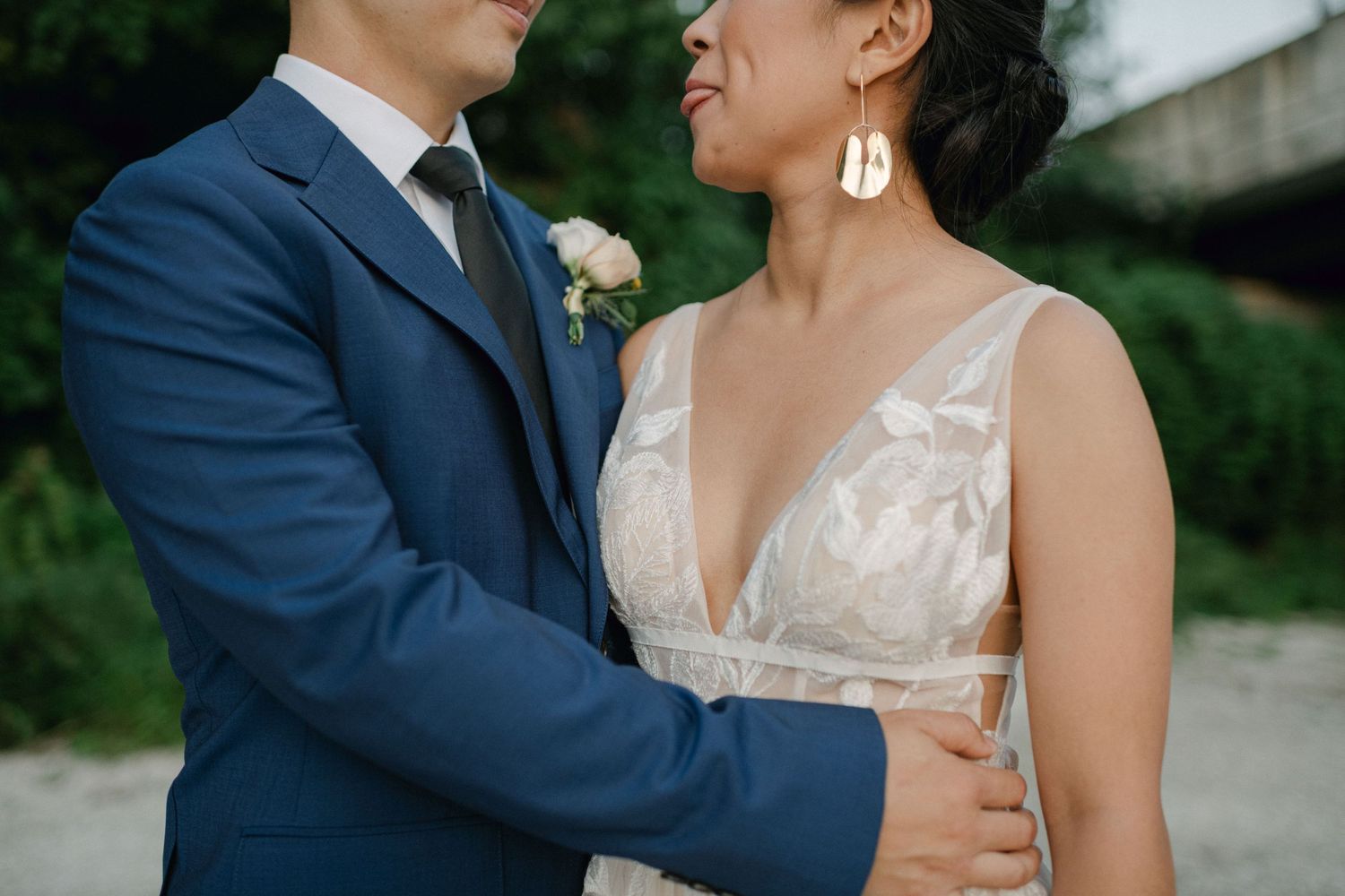 bride sticks her tongue out at groom