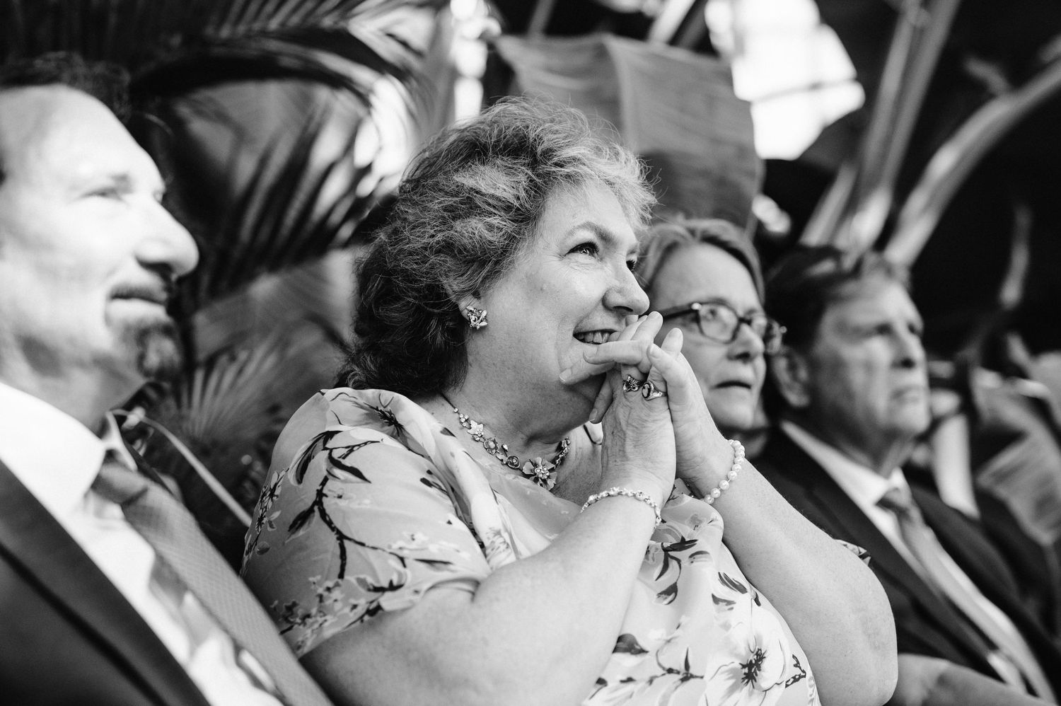 Black and white photo of wedding guests reacting emotionally during ceremony.
