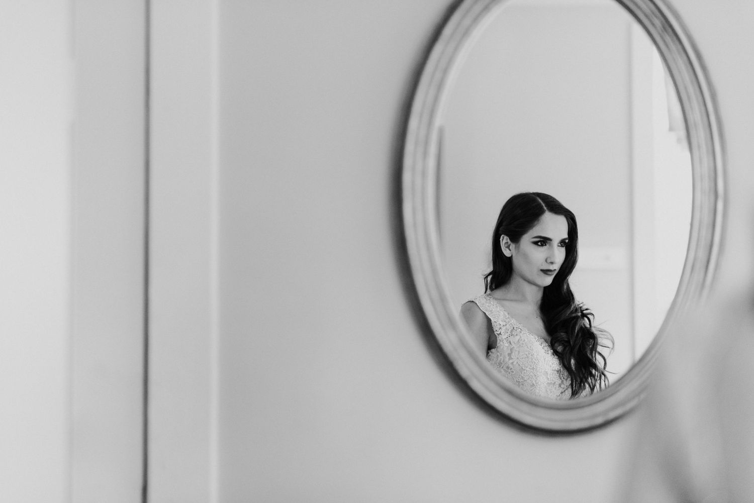 Artistic black and white reflection in an oval mirror.
