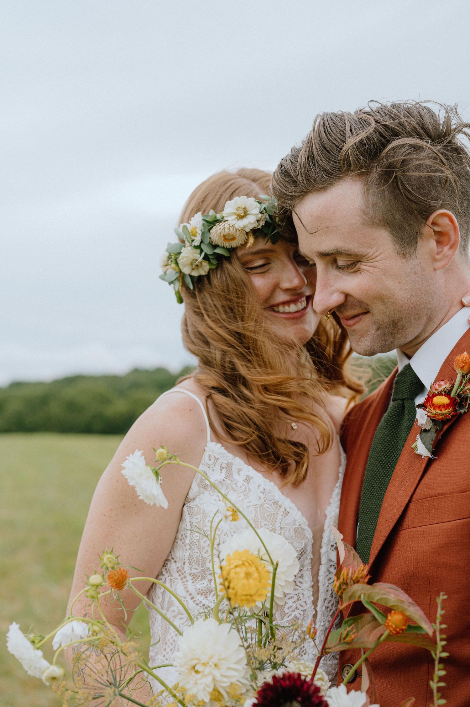 Intimate wedding portrait with colorful wildflower bouquet and floral crown.