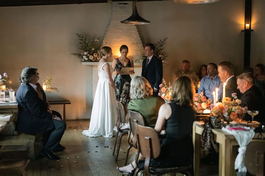 Atmospheric reception venue with pendant lights and guests seated at tables Fadensonnon in Baltimore