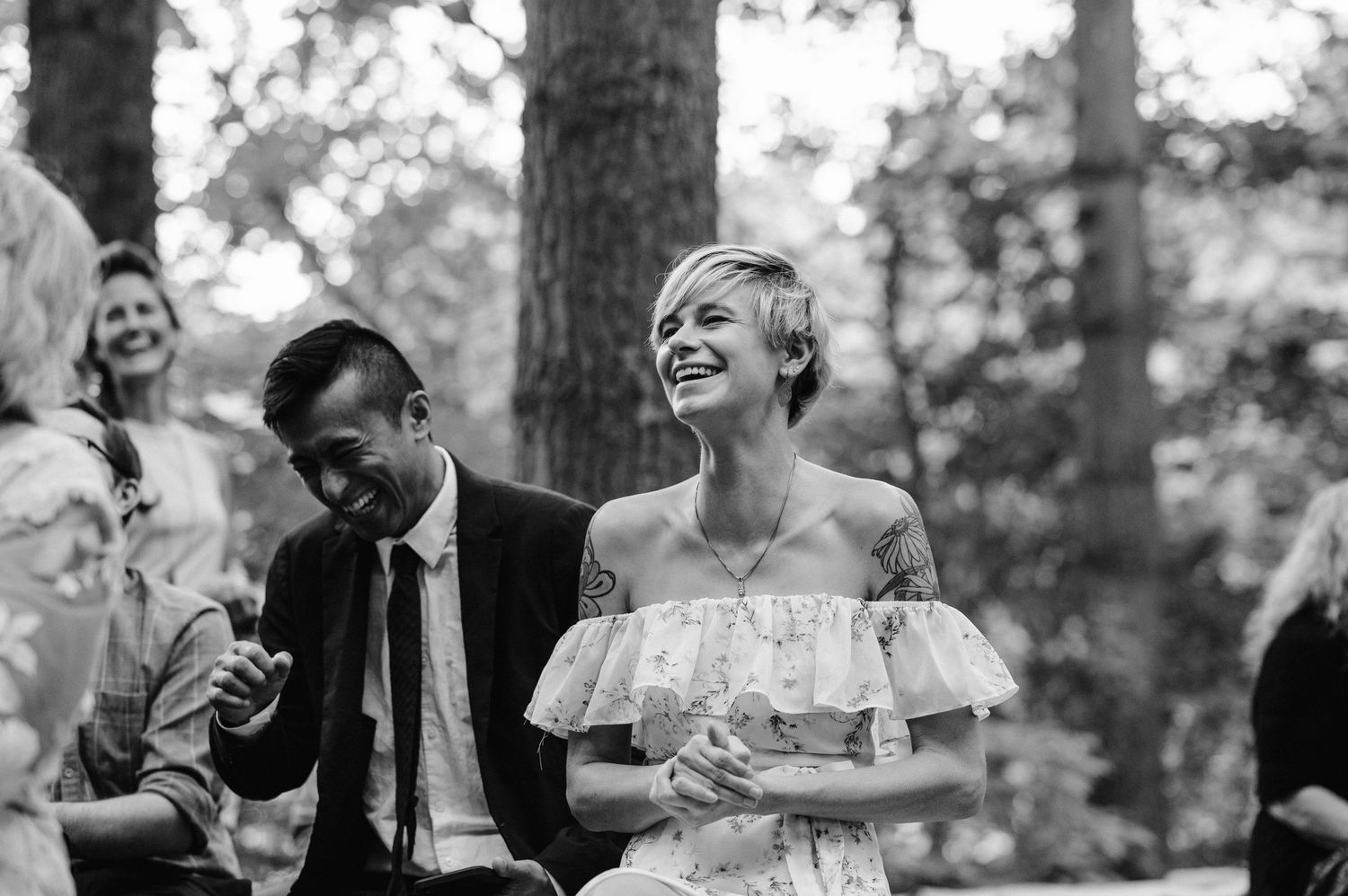 Joyful black and white moment captured during an outdoor wedding celebration.