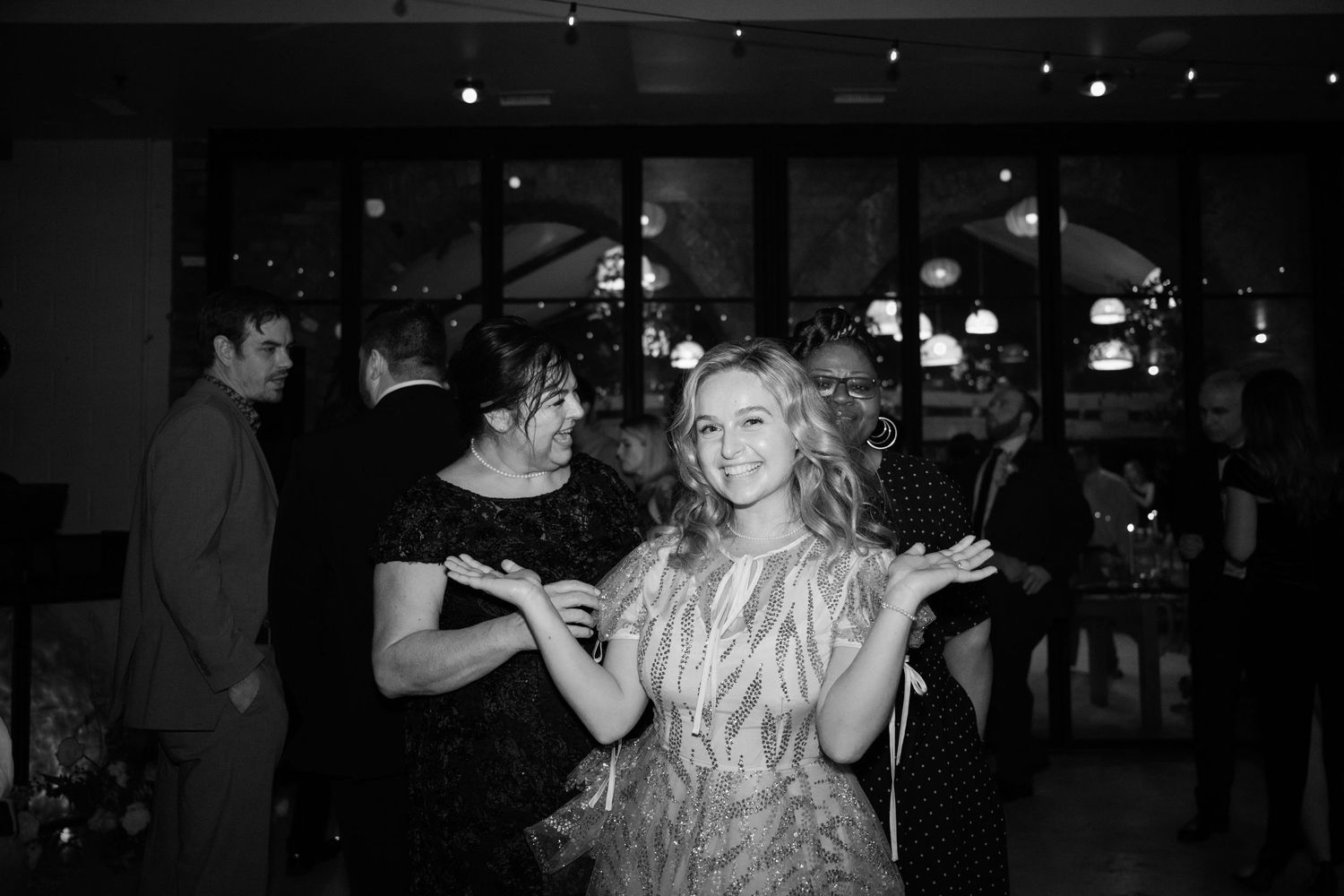 People dancing and having fun at a party under indoor lighting.