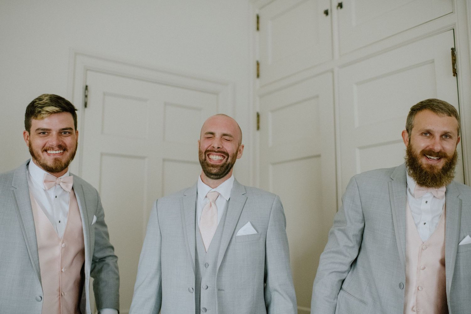 groom laughing with groomsmen
