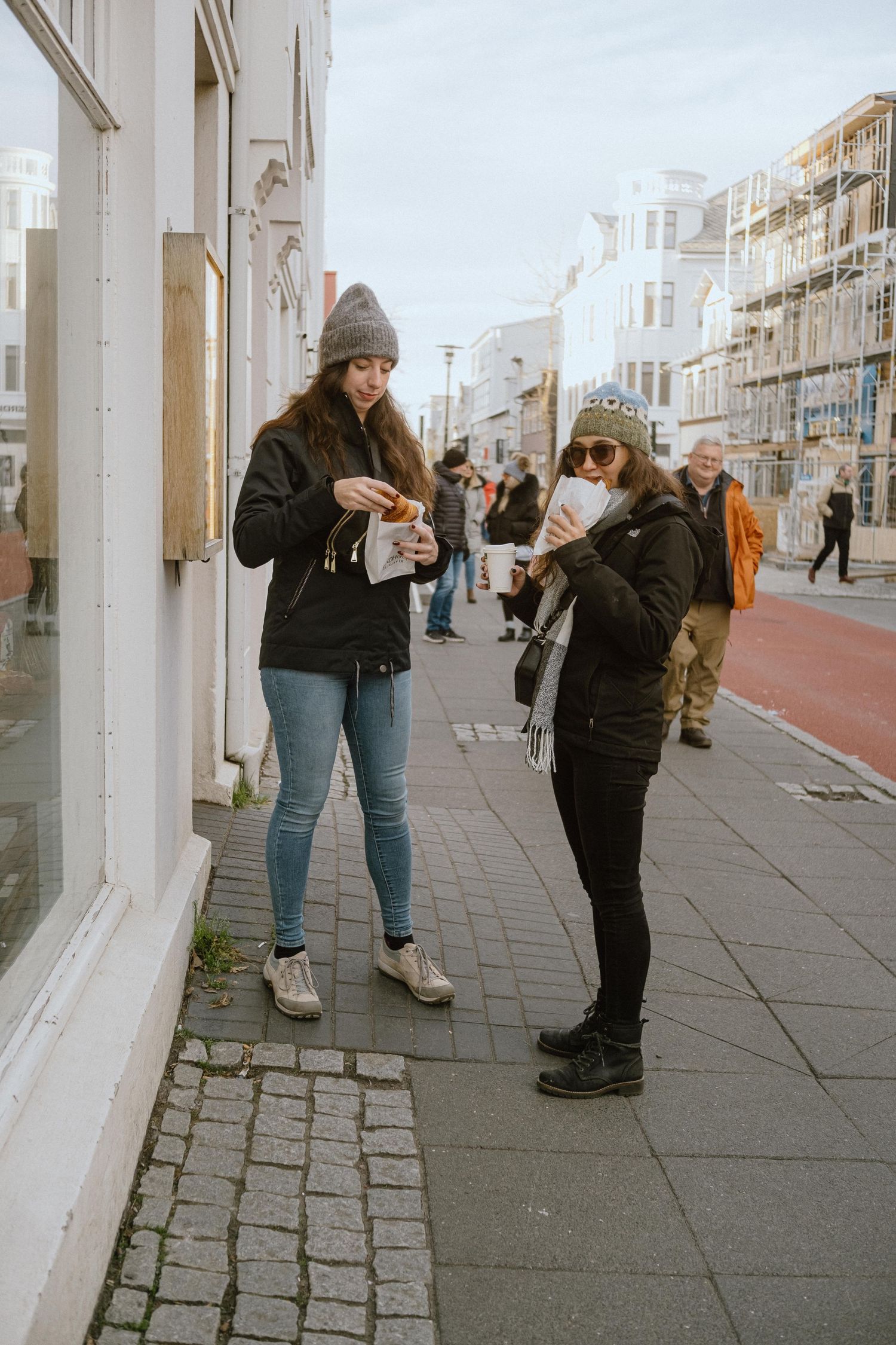 People browsing shops along a pedestrian street in downtown Reykjavik.