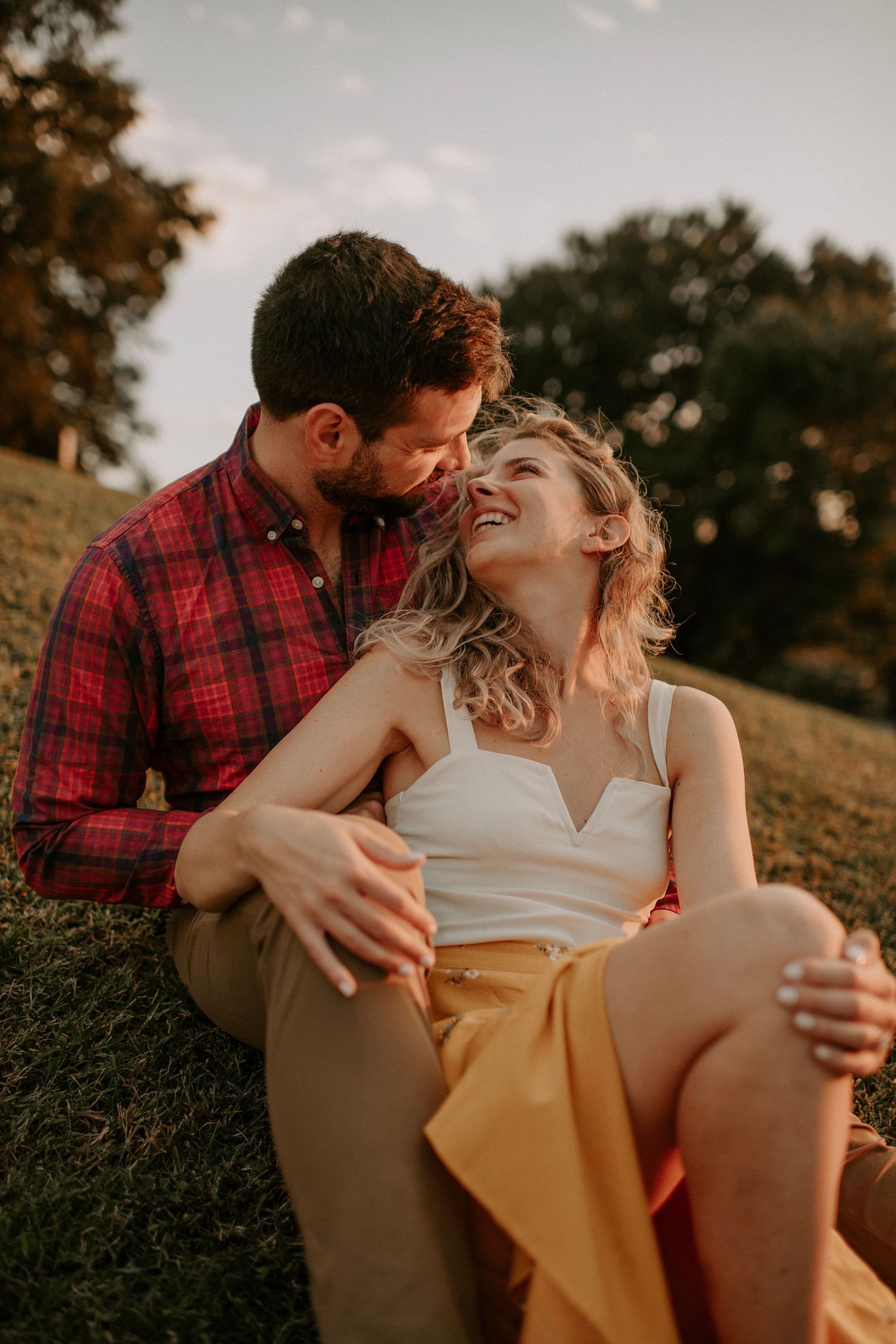 Intimate outdoor portrait session captured in warm sunset lighting.