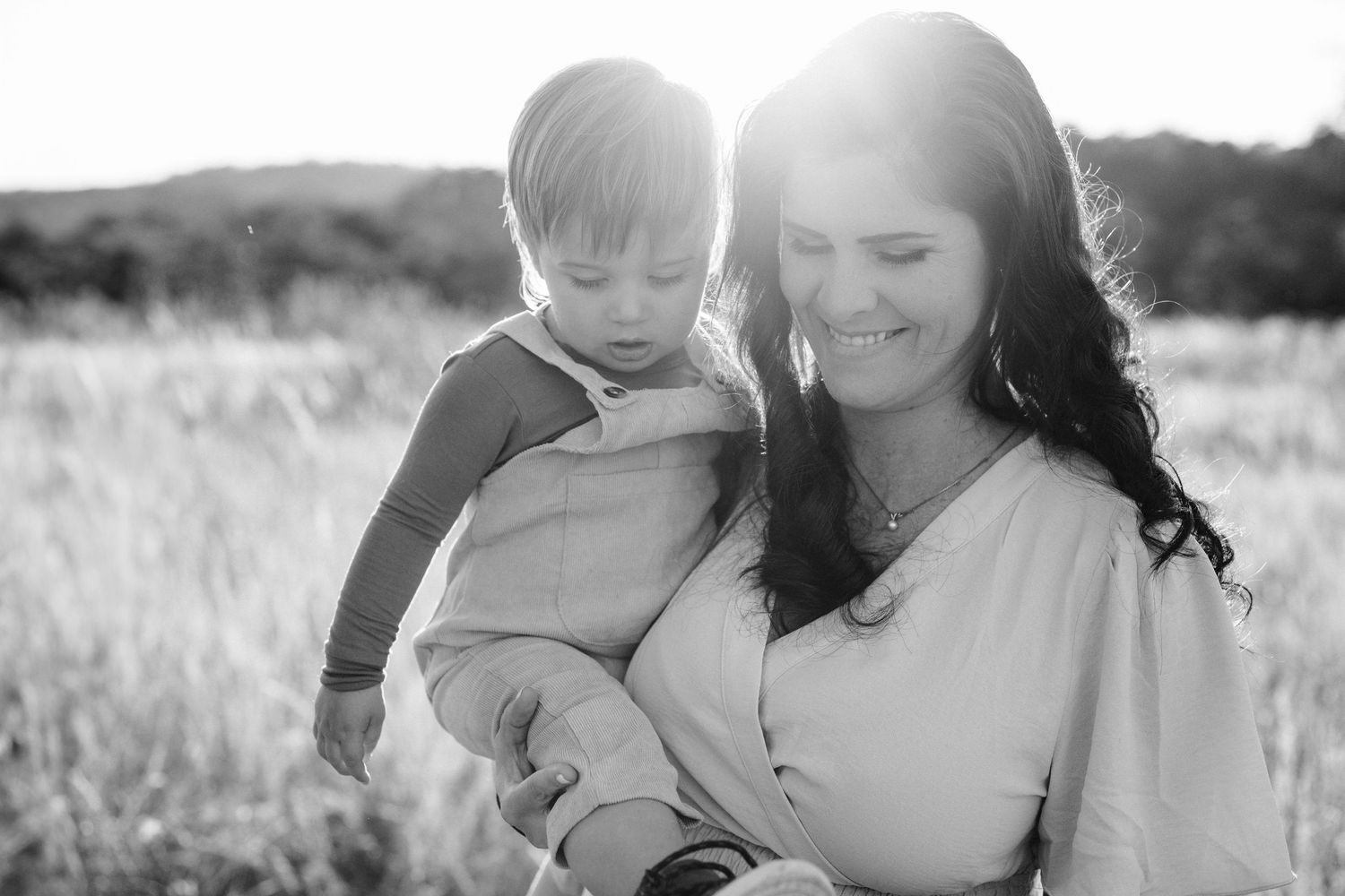 Black and white candid portrait of mother and child sharing tender moment.