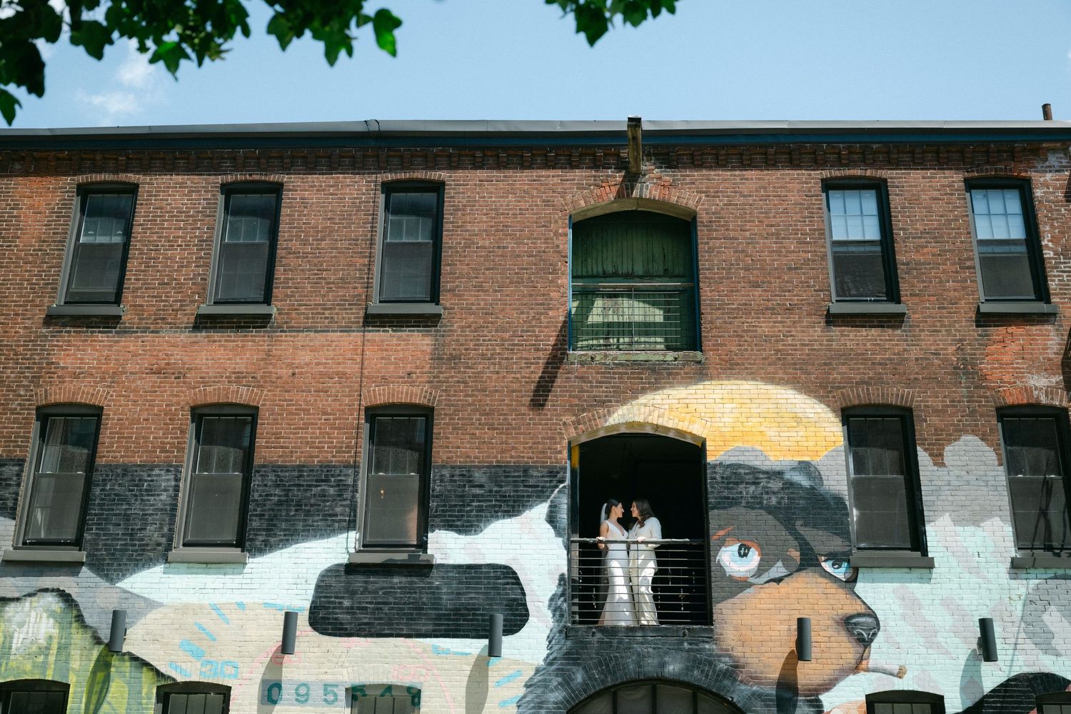 Exterior view of a historic brick building with decorative murals.