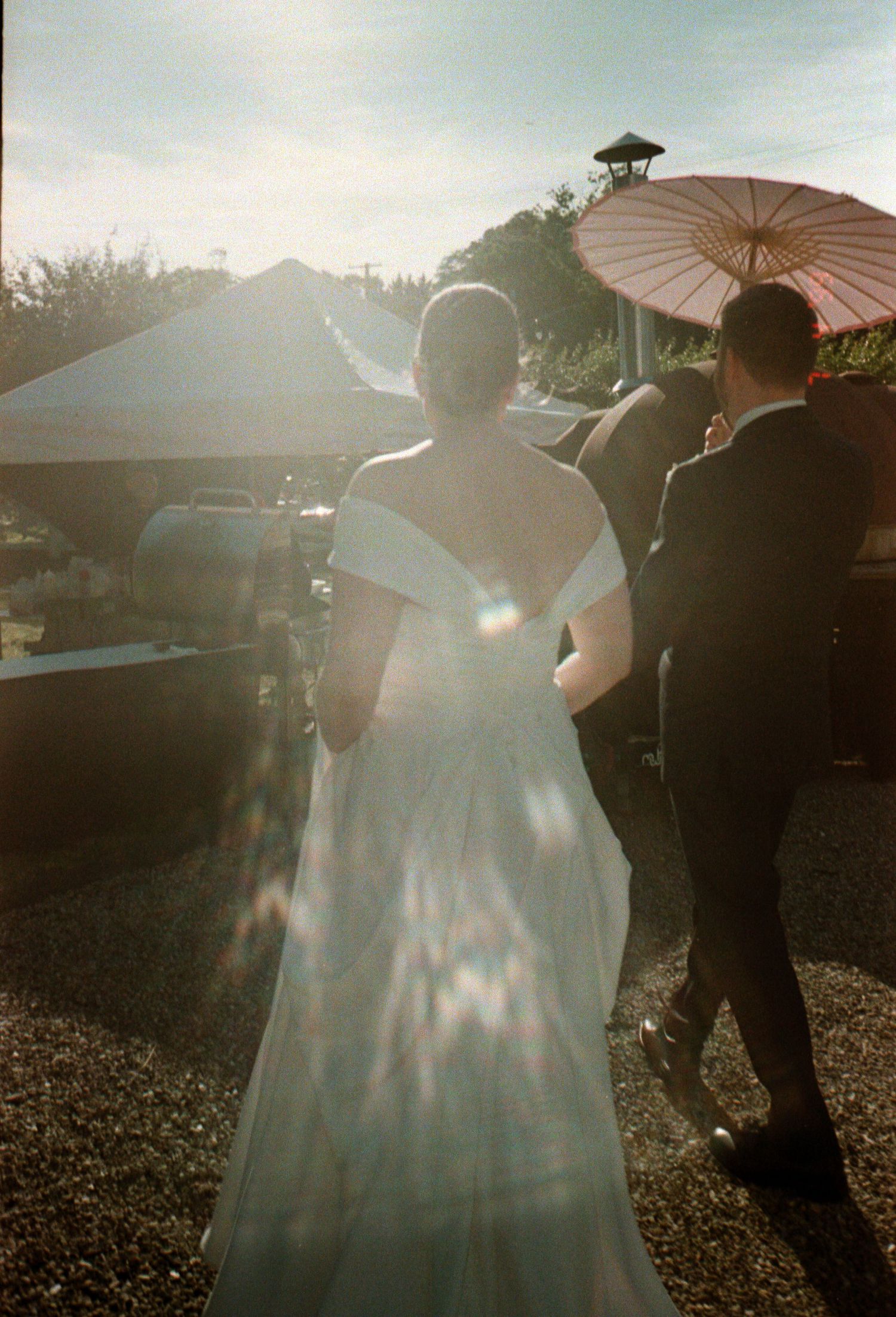 Elegant white house serves as backdrop for outdoor wedding celebration.