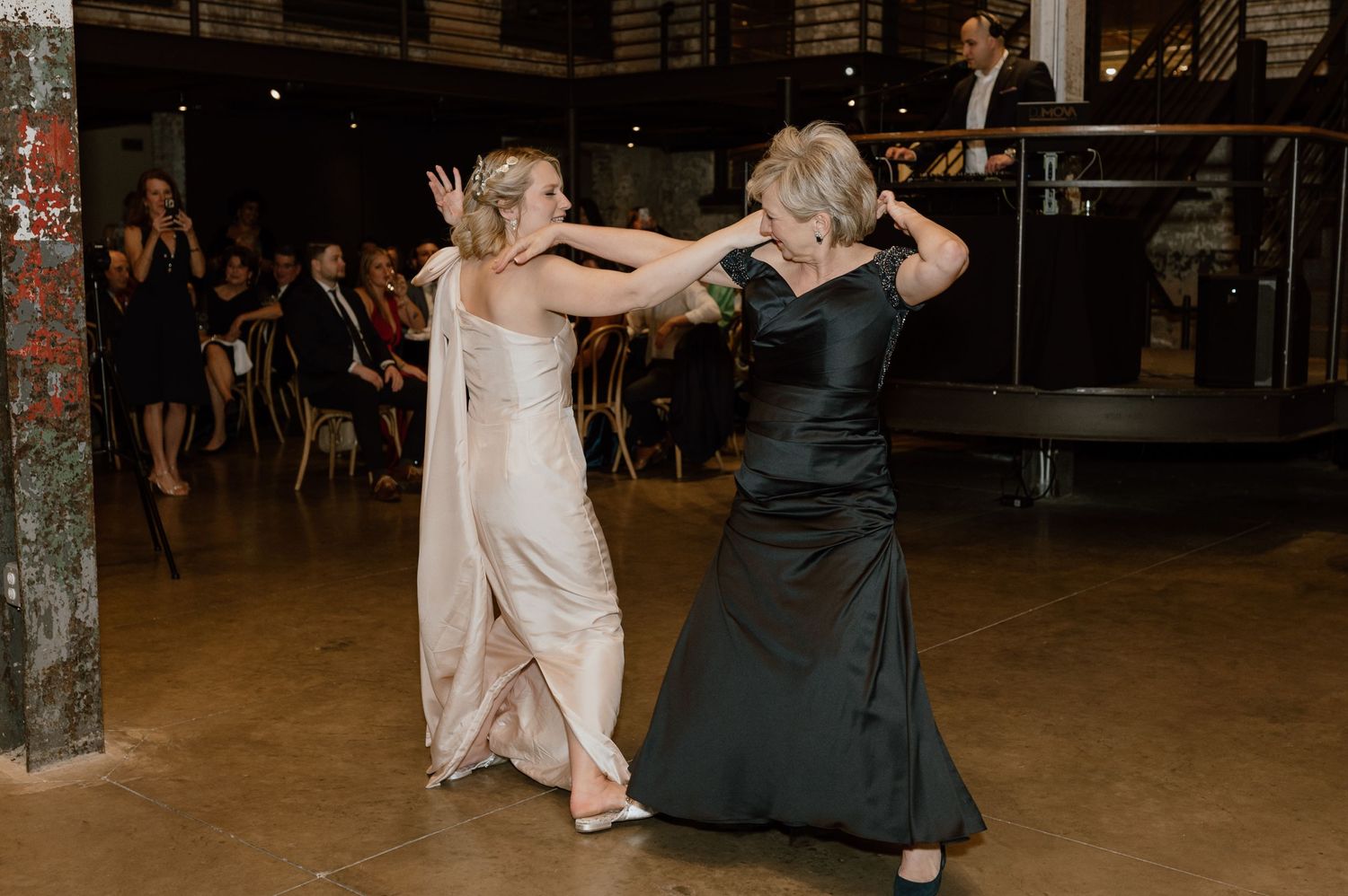 Dance partners enjoying a lively moment on the reception dance floor.
