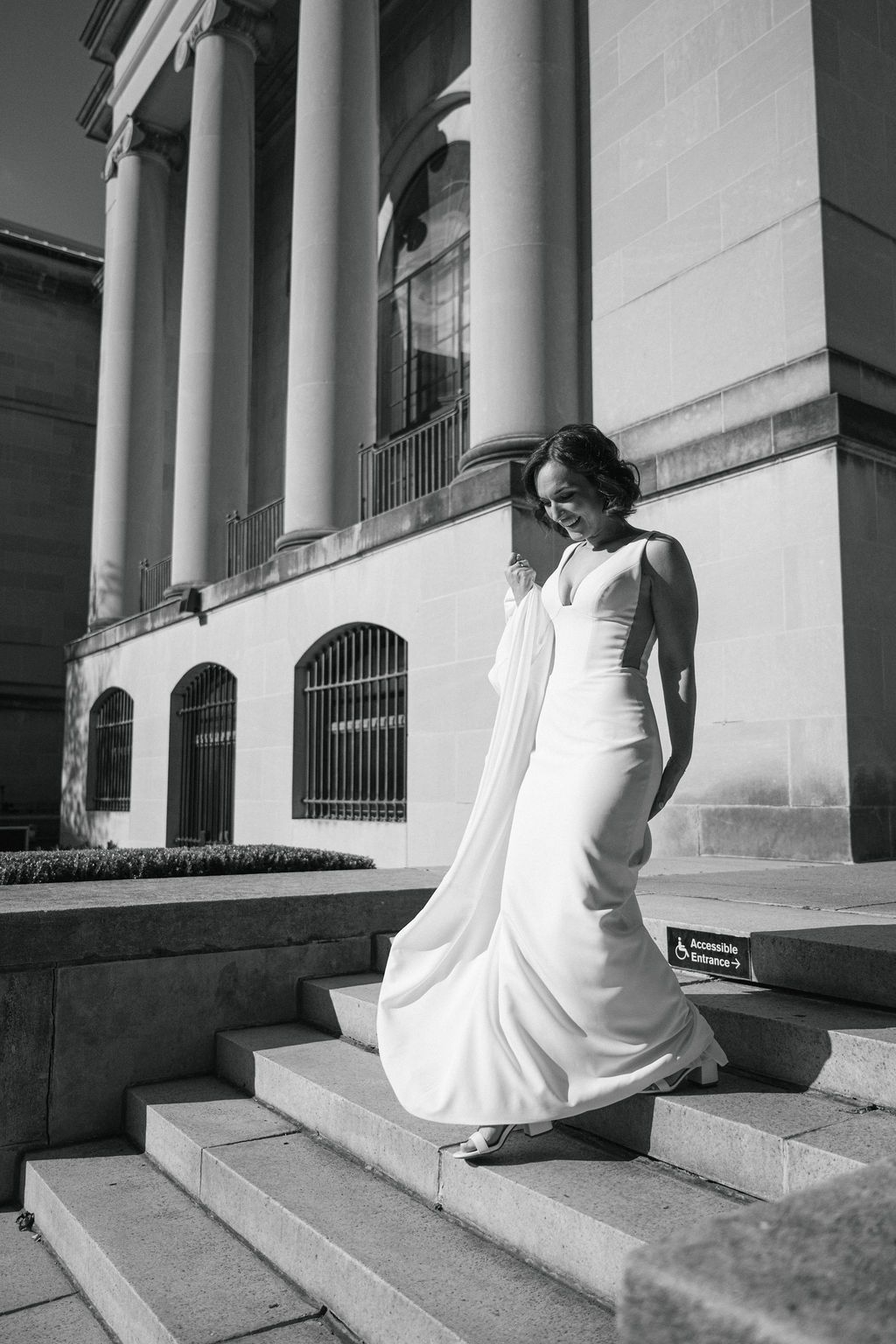 A person in a flowing white dress descends elegant stone steps in a series of artistic black and white photographs.