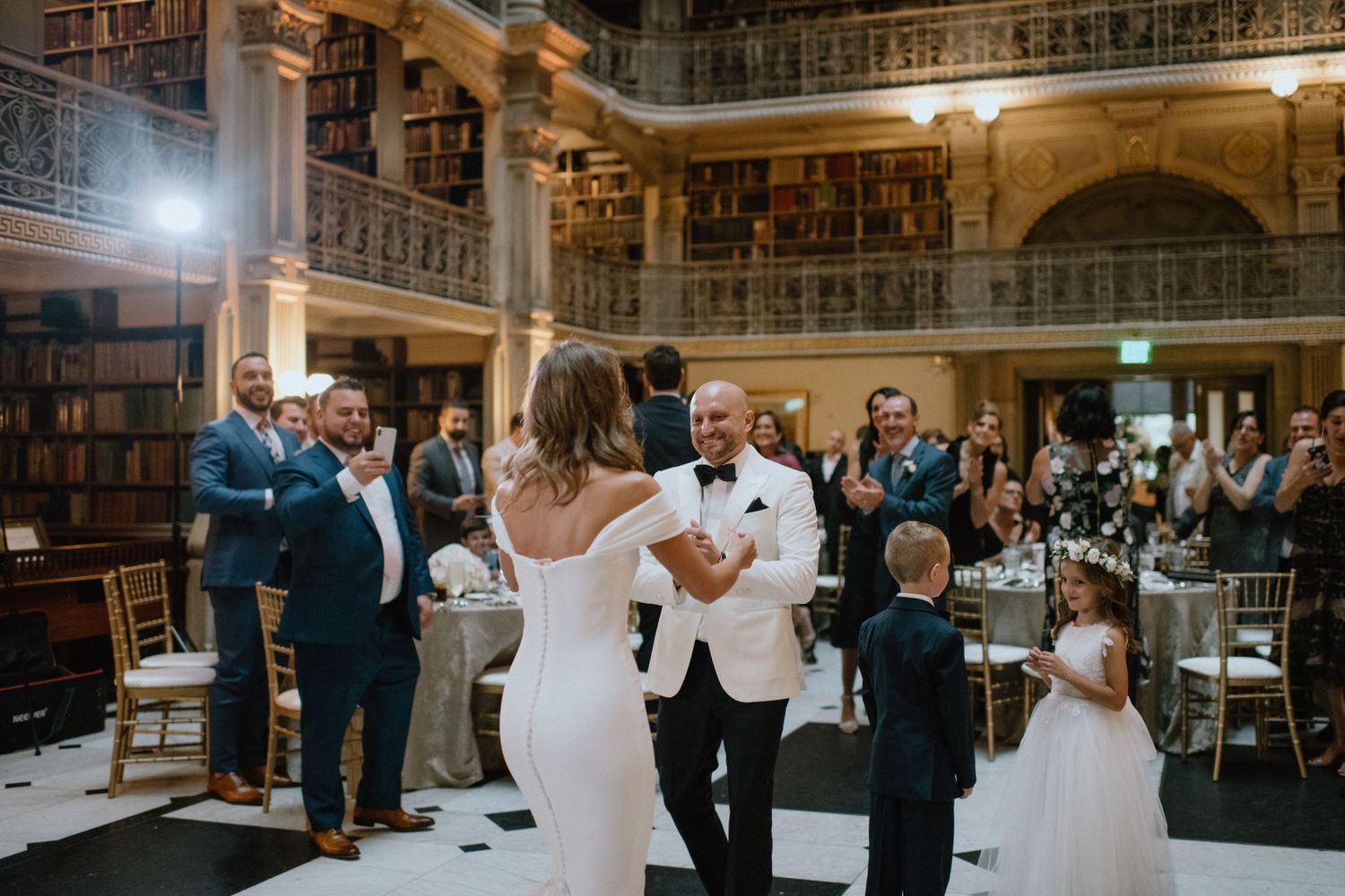 bride and groom enter reception space