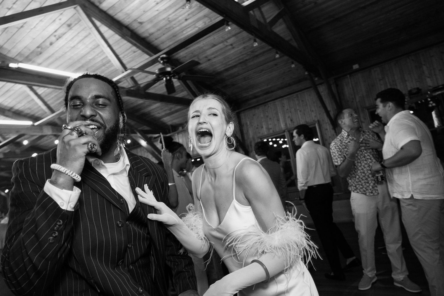 Black and white capture of joyous celebration at an indoor event.