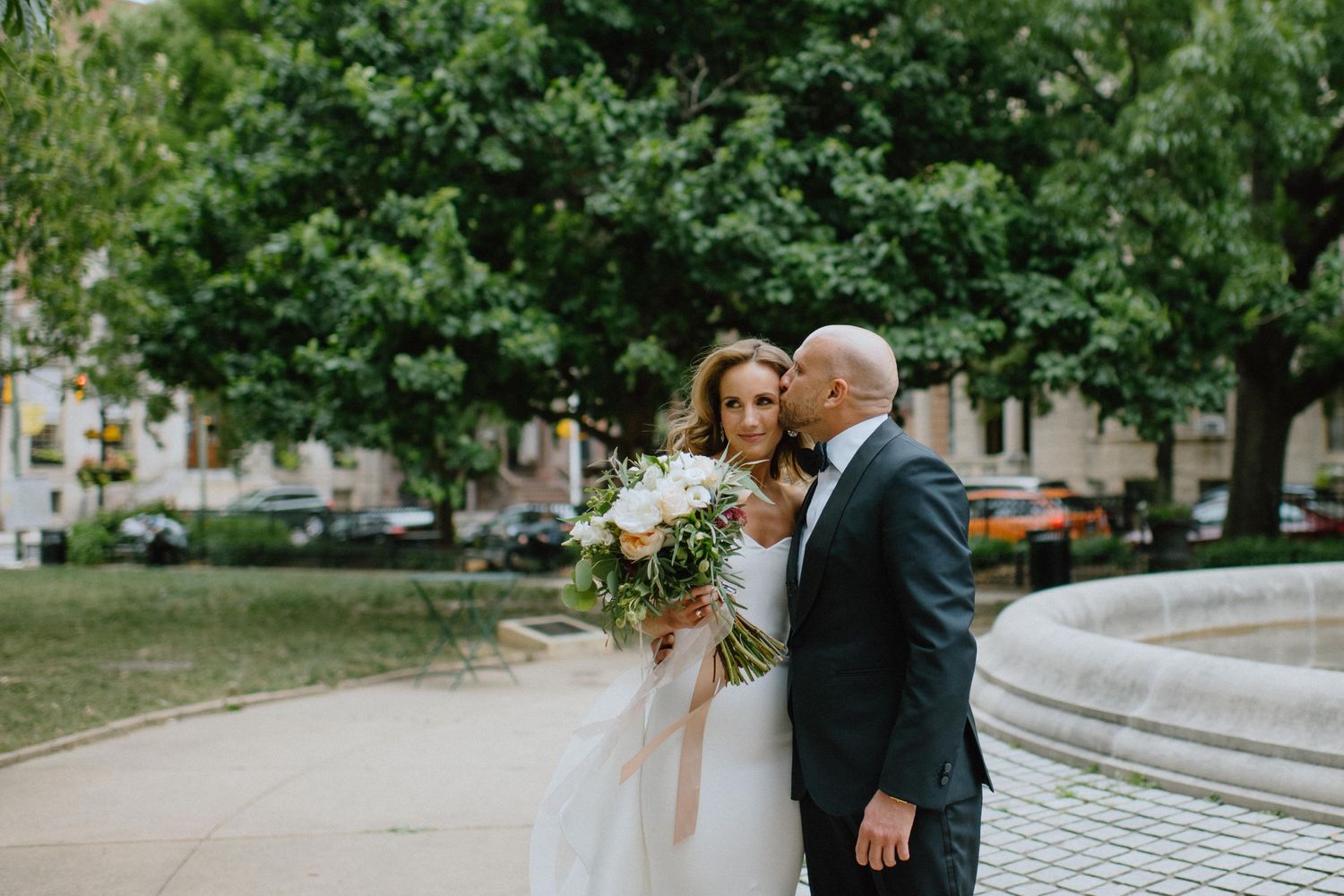 groom kisses bride after first look