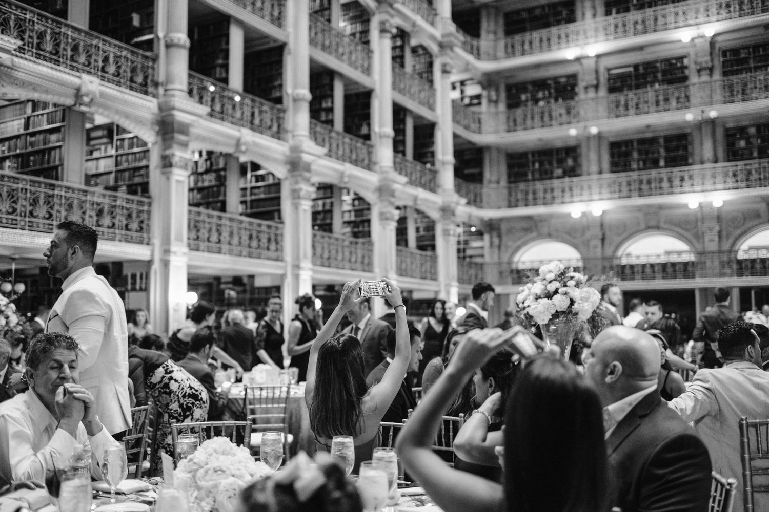 guests take pictures of peabody library reception space with cell phones