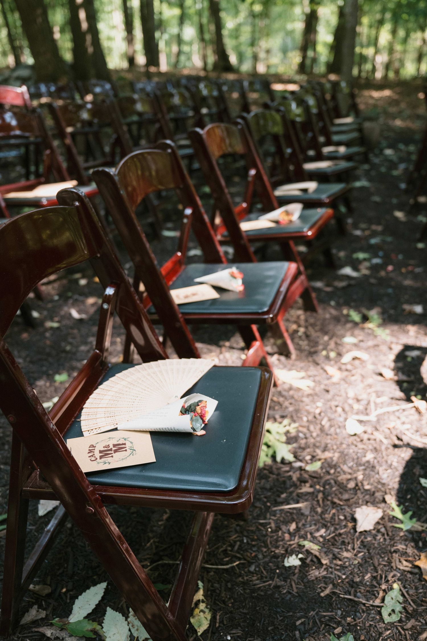 chairs at ceremony space with fans on them