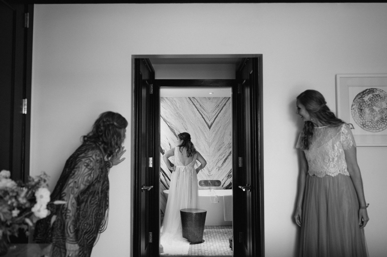 Black and white hallway sequence showing wedding preparation moments through doorways.