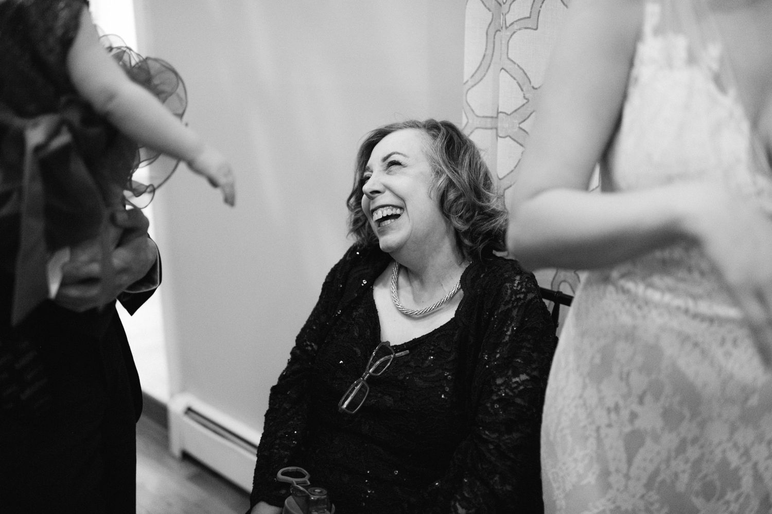 Candid black and white photo capturing a moment of pure joy during a celebration.
